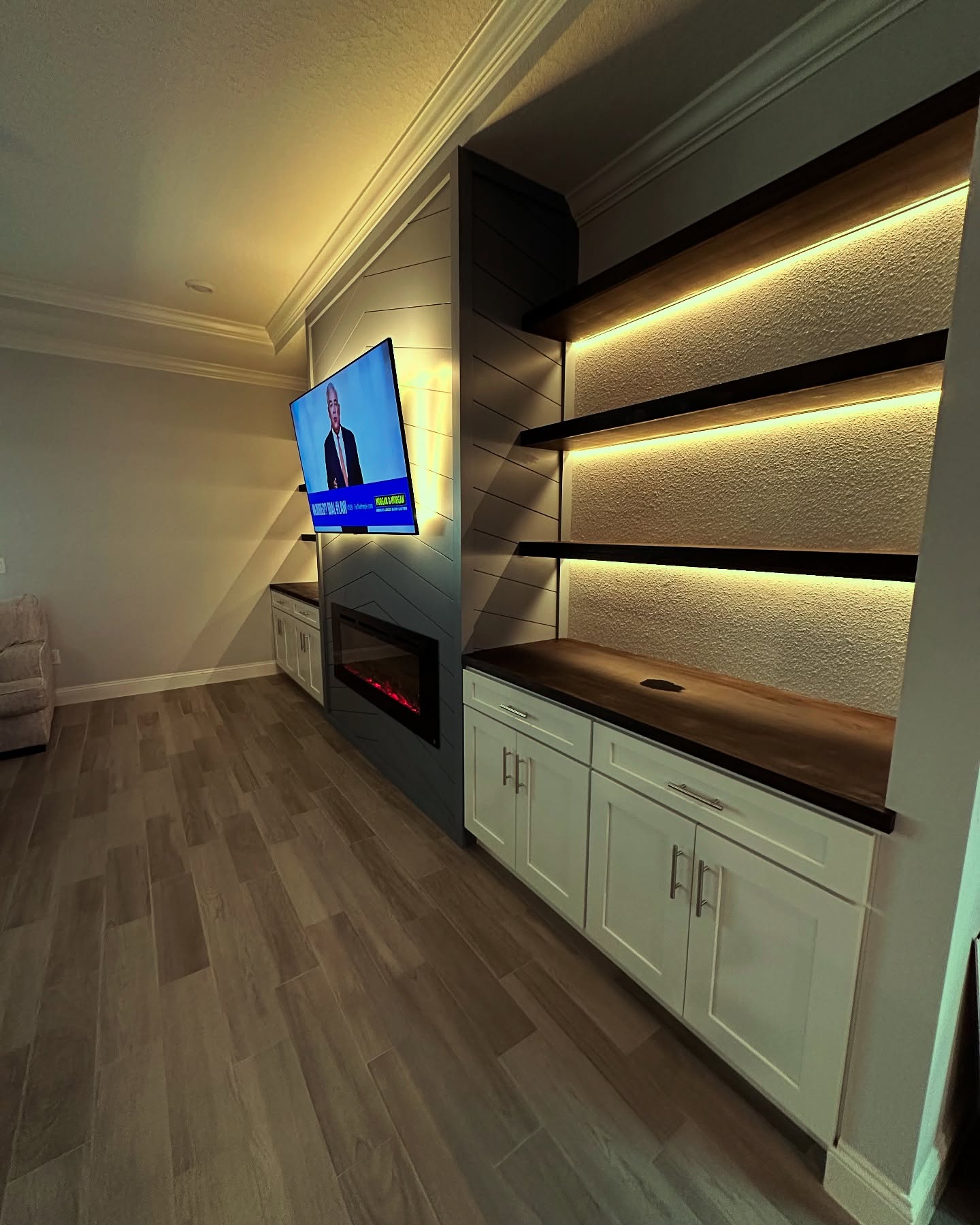 Built-in TV cabinet flanked by display shelving by AVP Construction JAX — Jacksonville & St. John's County, FL