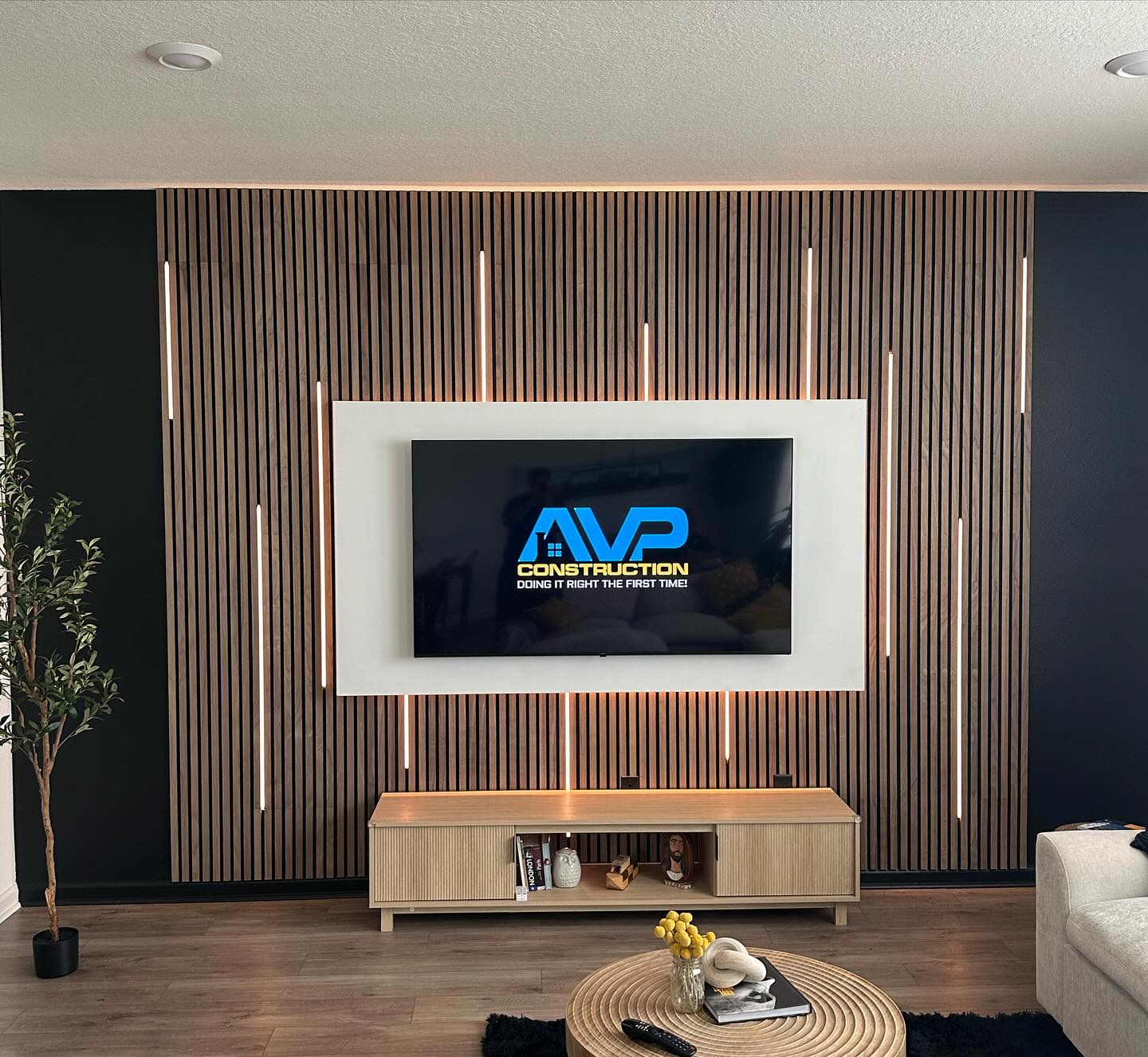 Wall-mounted TV with under-cabinet storage by AVP Construction JAX — Jacksonville & St. John's County, FL