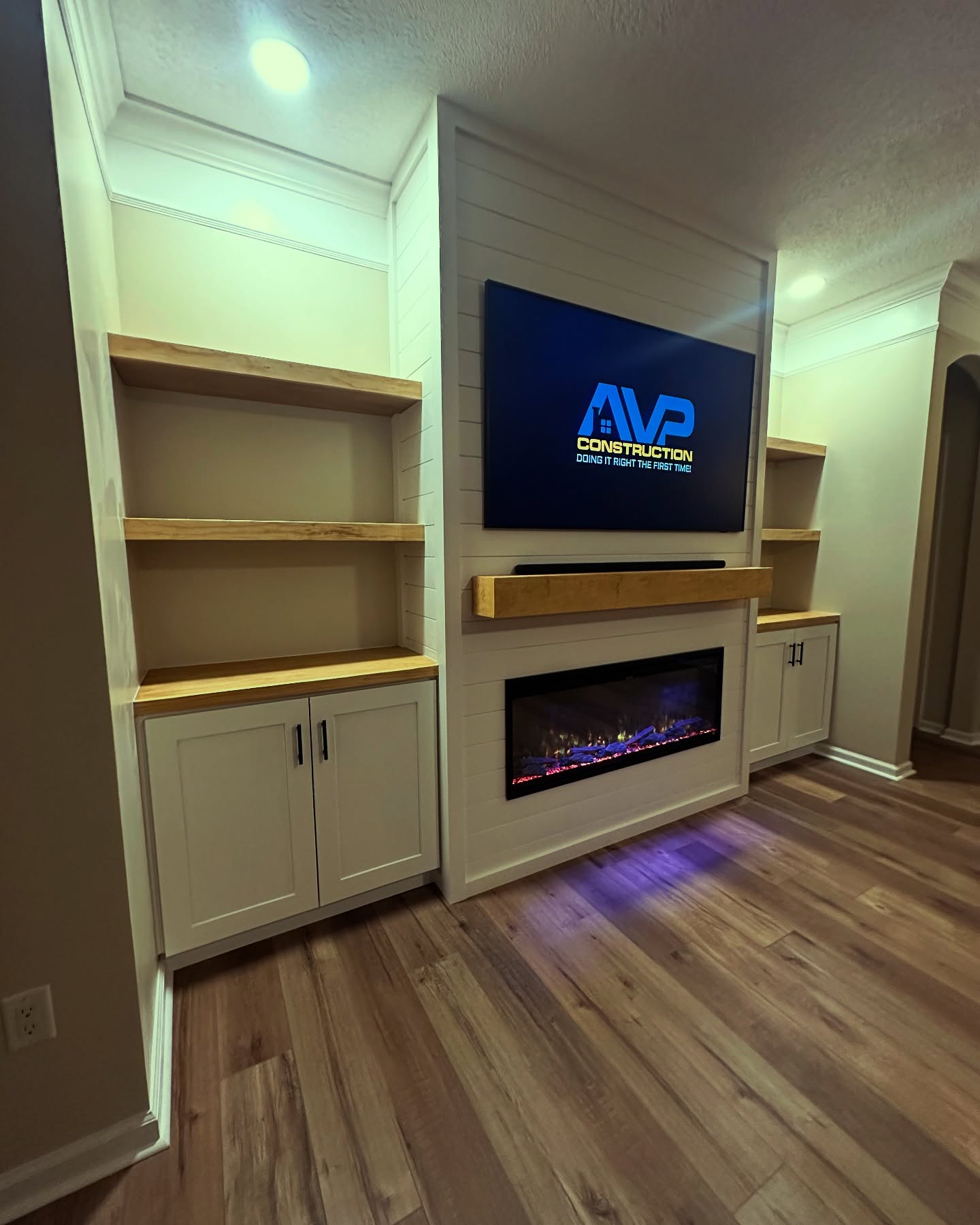 Modern entertainment center with electric fireplace by AVP Construction JAX — Jacksonville & St. John's County, FL