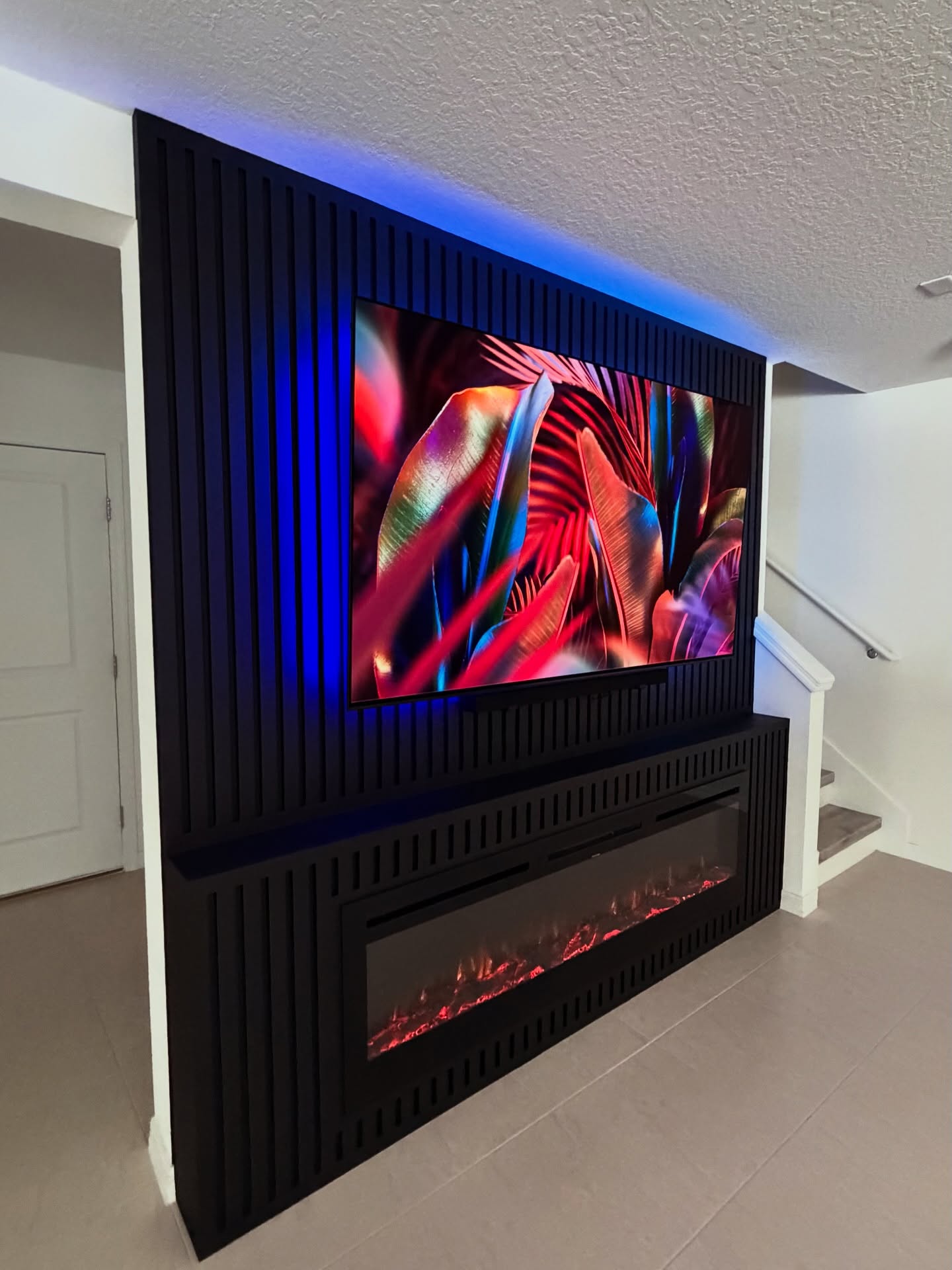 Custom living-room media wall with paneling by AVP Construction JAX — Jacksonville & St. John's County, FL