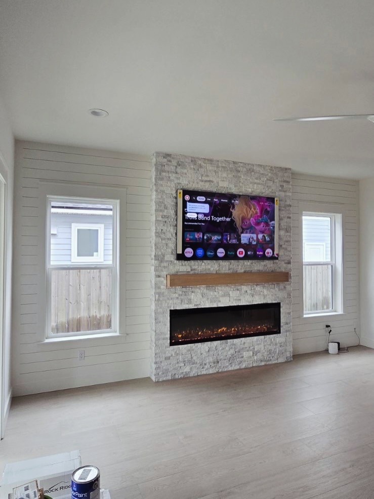 Custom living-room media wall with paneling by AVP Construction JAX — Jacksonville & St. John's County, FL