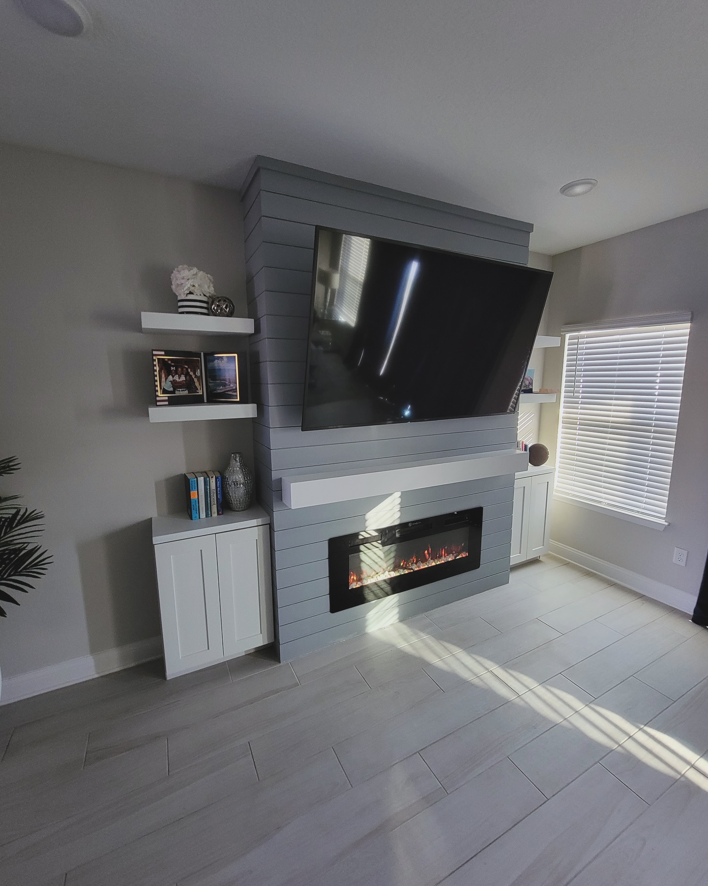 Floating-shelf TV built-in with shaker cabinets by AVP Construction JAX — Jacksonville & St. John's County, FL