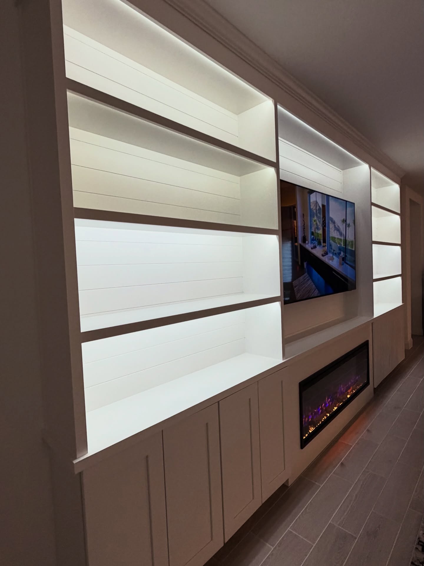 Built-in TV cabinet flanked by display shelving by AVP Construction JAX — Jacksonville & St. John's County, FL