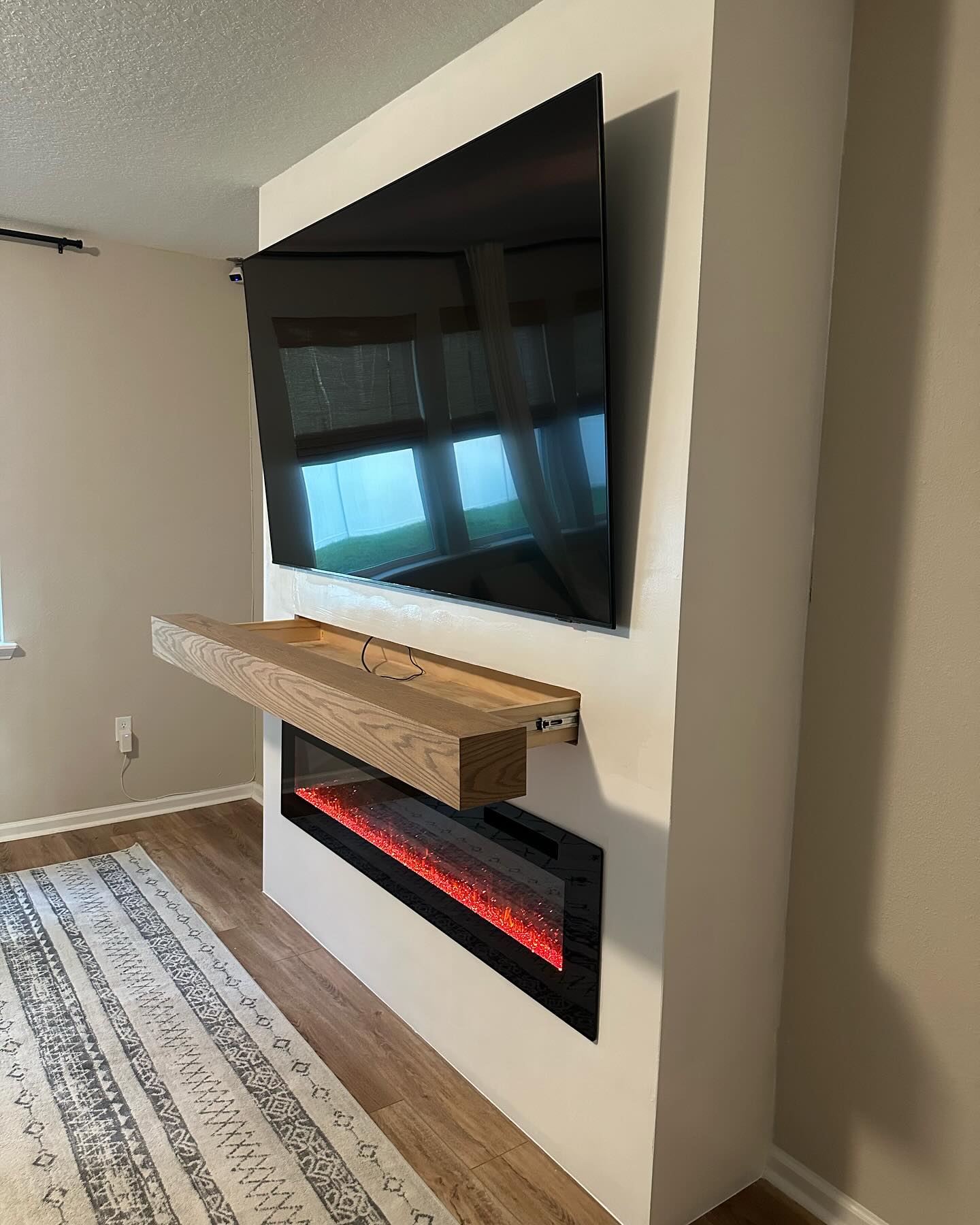 Modern entertainment center with electric fireplace by AVP Construction JAX — Jacksonville & St. John's County, FL