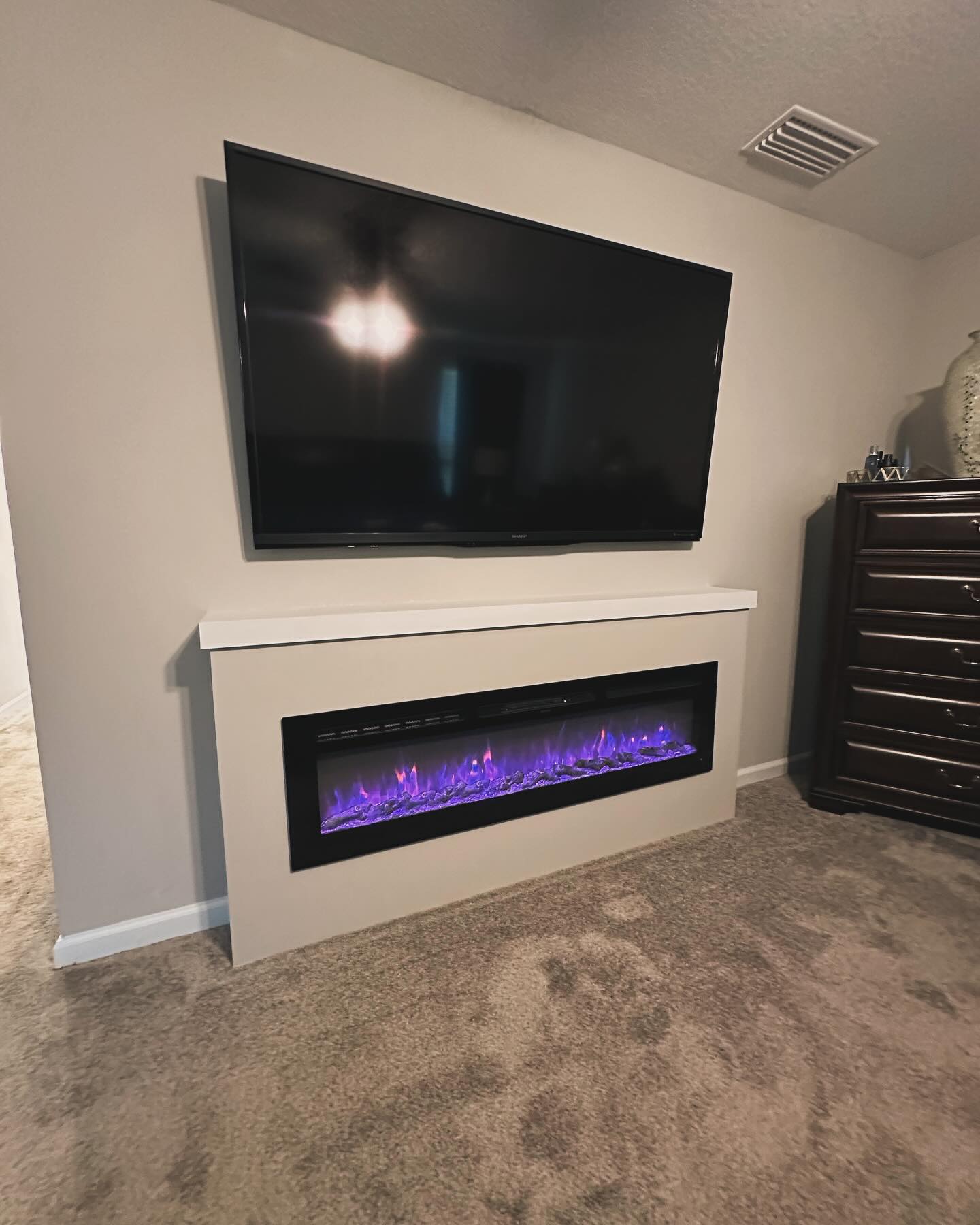 Floor-to-ceiling media wall with custom millwork by AVP Construction JAX — Jacksonville & St. John's County, FL