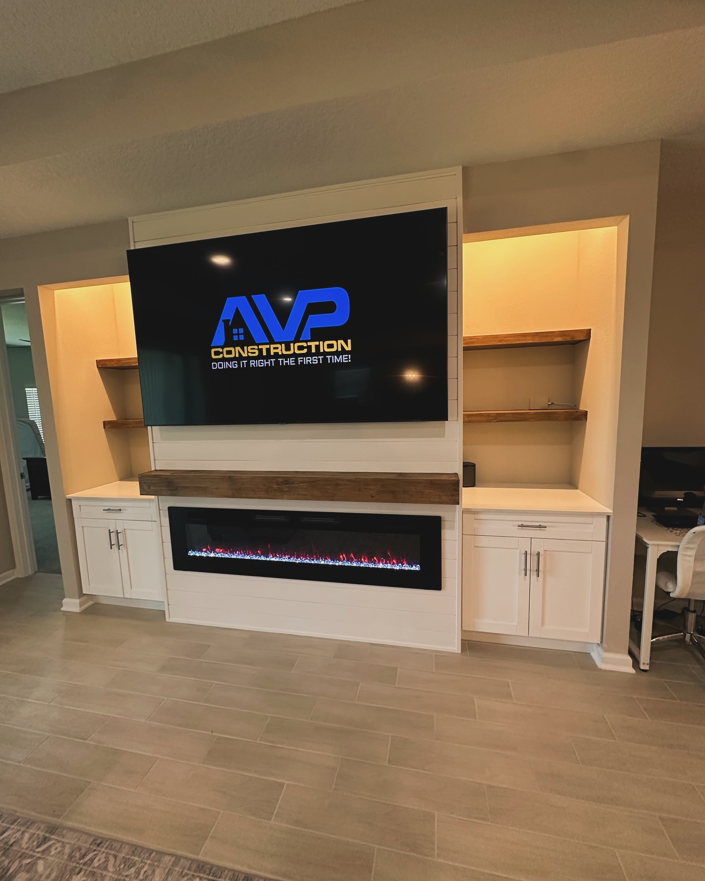 Floating-shelf TV built-in with shaker cabinets by AVP Construction JAX — Jacksonville & St. John's County, FL