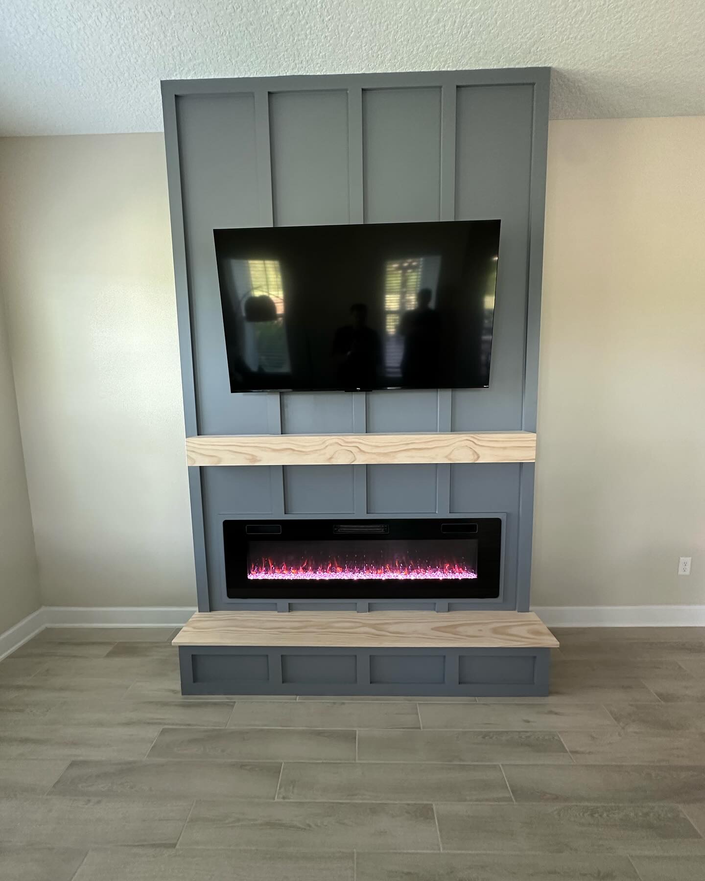 Wall-mounted TV with under-cabinet storage by AVP Construction JAX — Jacksonville & St. John's County, FL