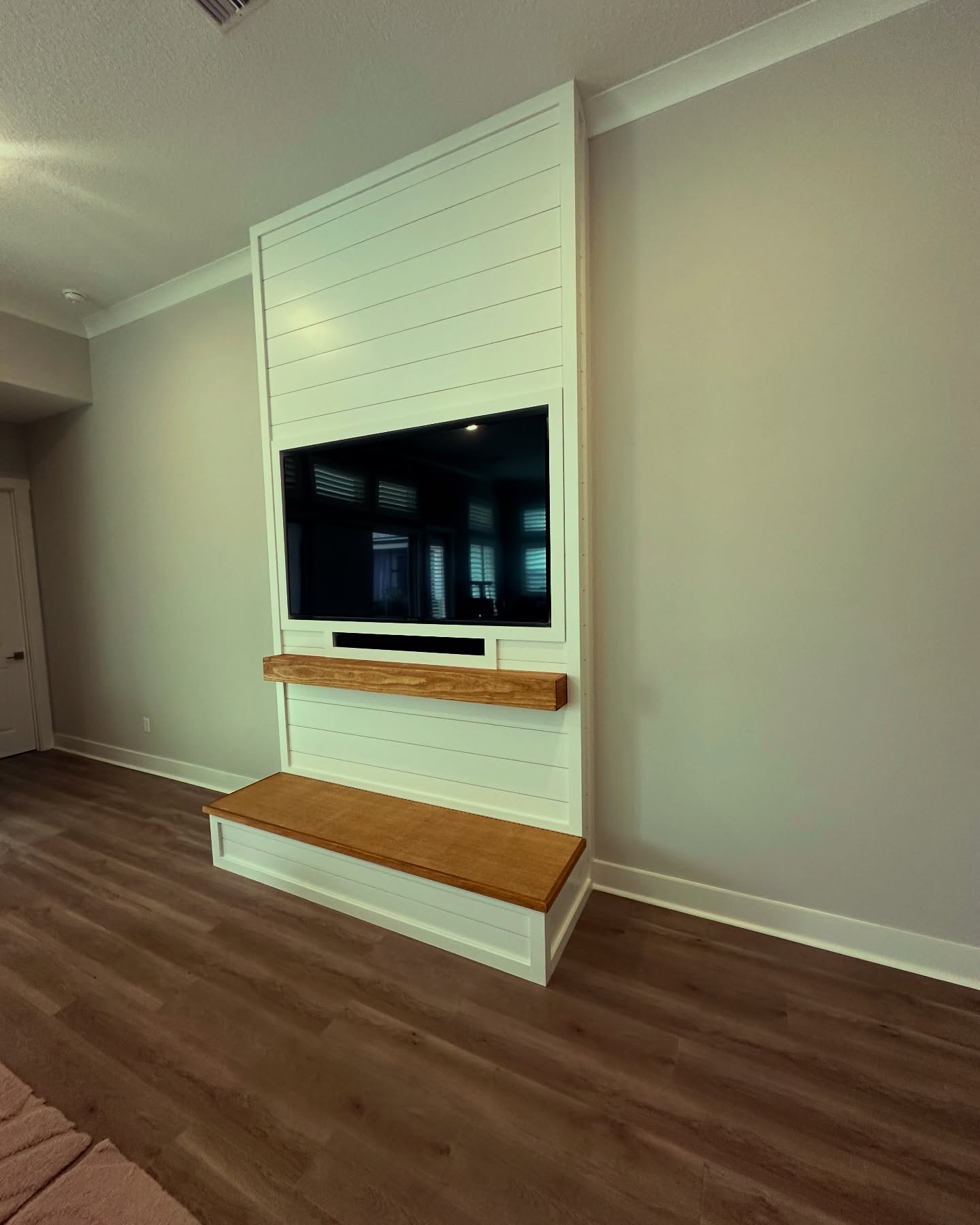 Floating-shelf TV built-in with shaker cabinets by AVP Construction JAX — Jacksonville & St. John's County, FL