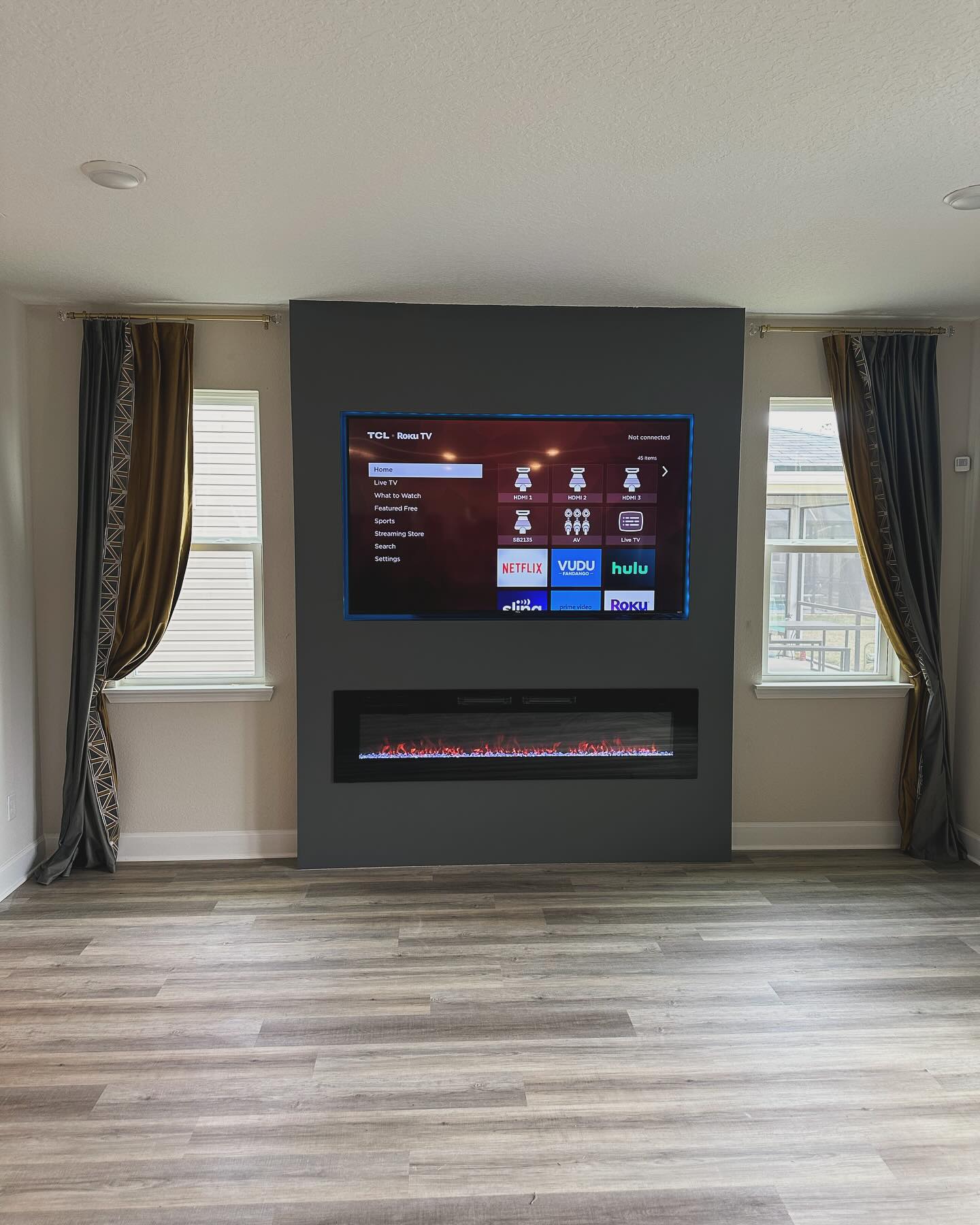Wall-mounted TV with under-cabinet storage by AVP Construction JAX — Jacksonville & St. John's County, FL