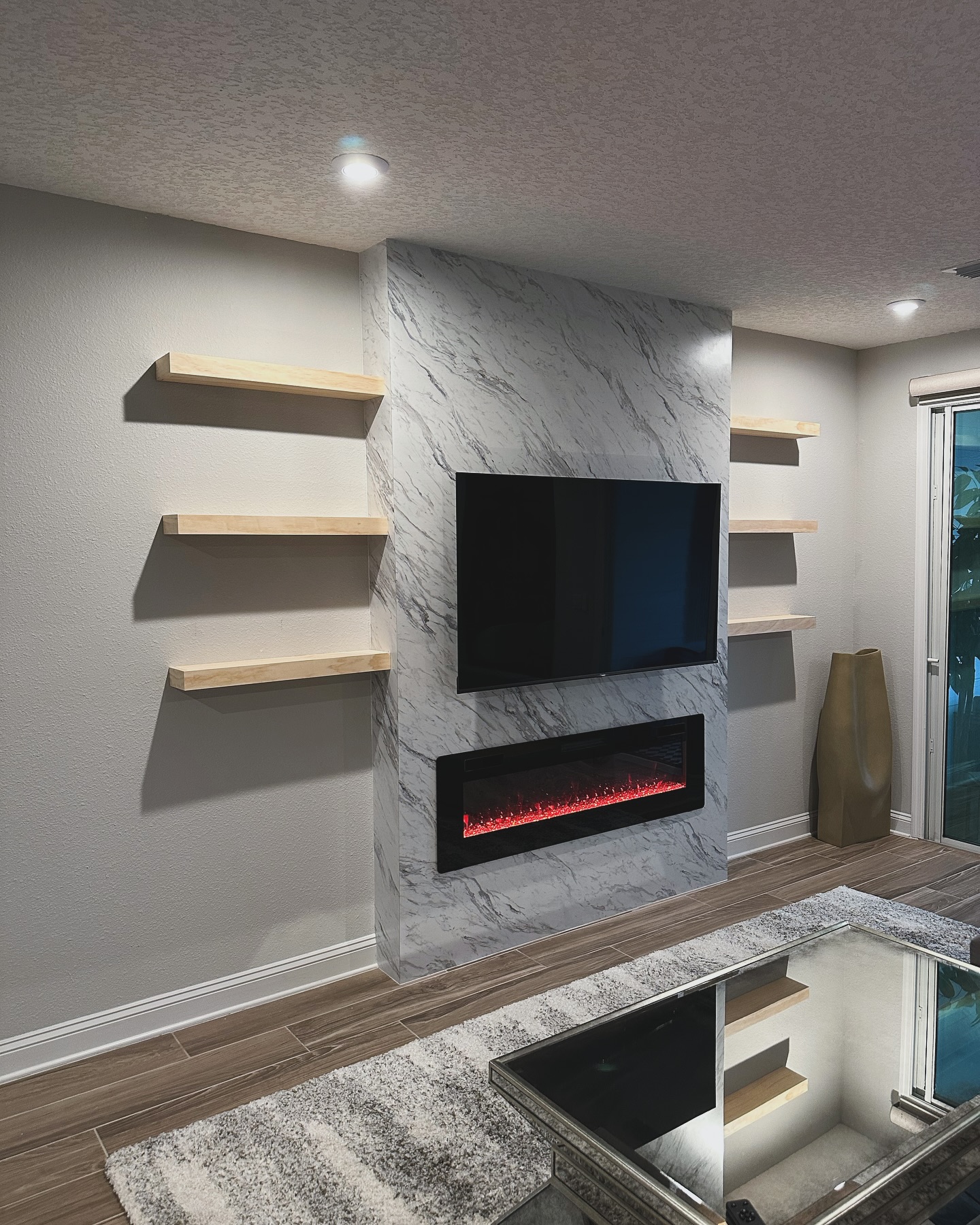 Wall-mounted TV with under-cabinet storage by AVP Construction JAX — Jacksonville & St. John's County, FL