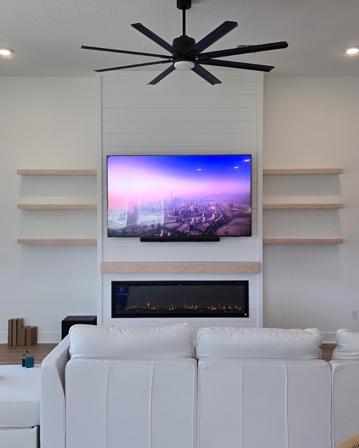 Modern entertainment center with electric fireplace by AVP Construction JAX — Jacksonville & St. John's County, FL