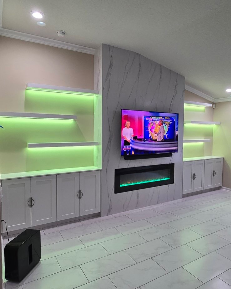 Built-in TV cabinet flanked by display shelving by AVP Construction JAX — Jacksonville & St. John's County, FL