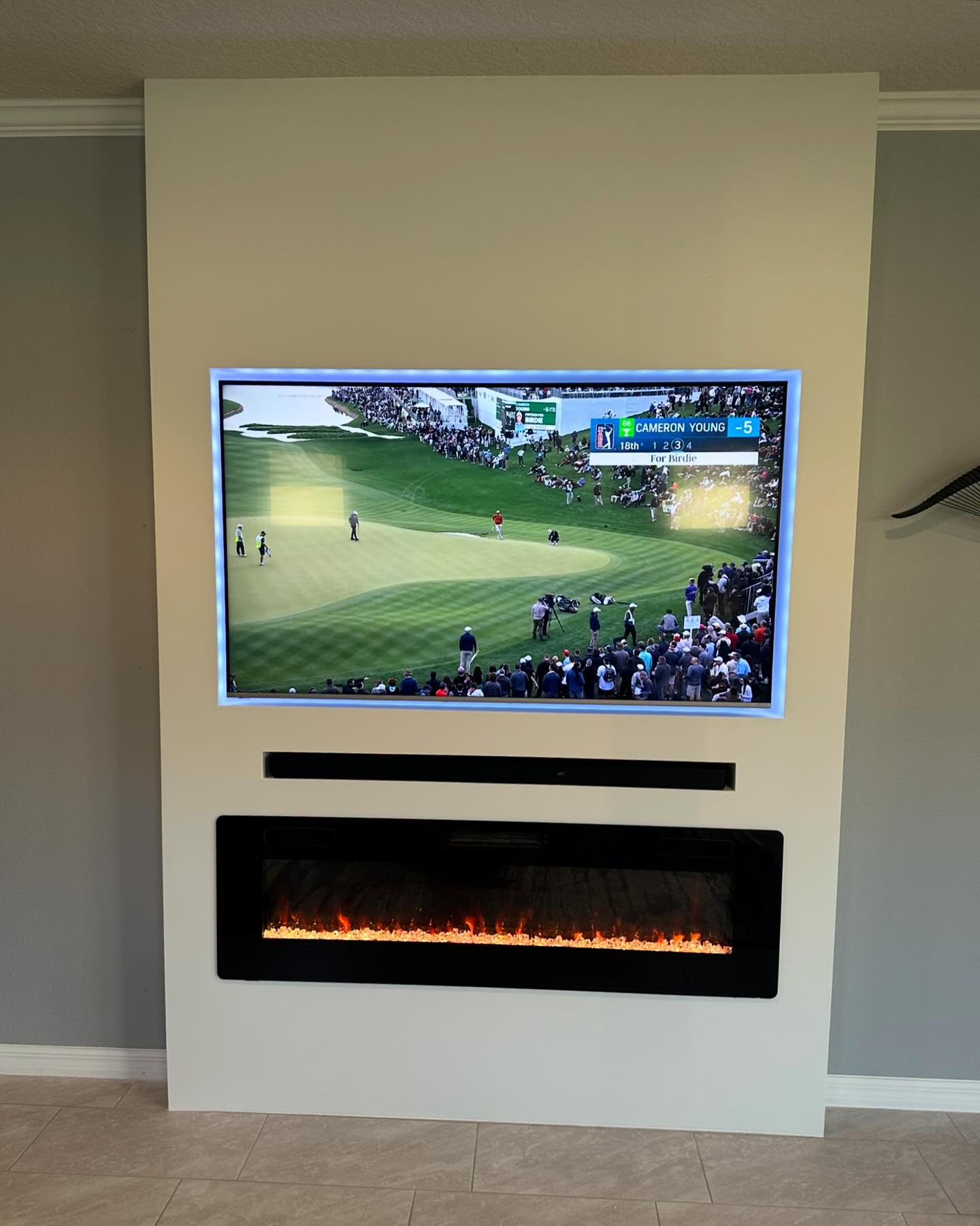 Wall-mounted TV with under-cabinet storage by AVP Construction JAX — Jacksonville & St. John's County, FL