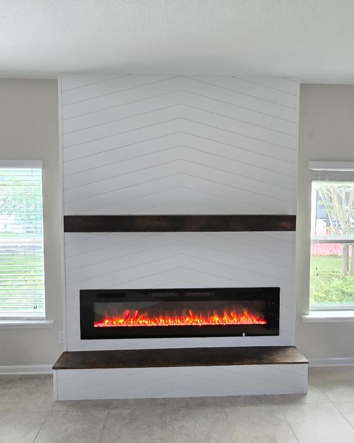 Modern entertainment center with electric fireplace by AVP Construction JAX — Jacksonville & St. John's County, FL