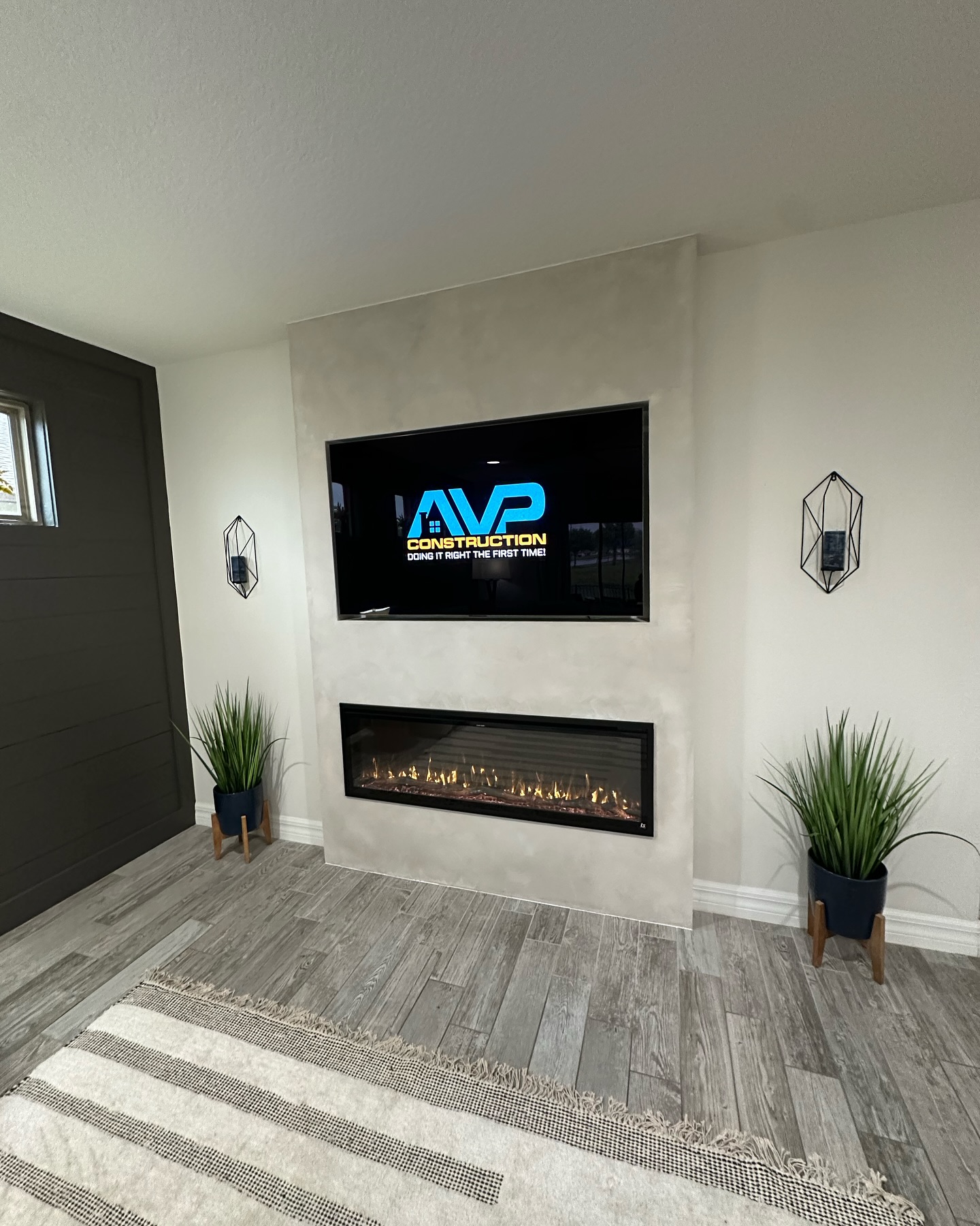 Modern entertainment center with electric fireplace by AVP Construction JAX — Jacksonville & St. John's County, FL