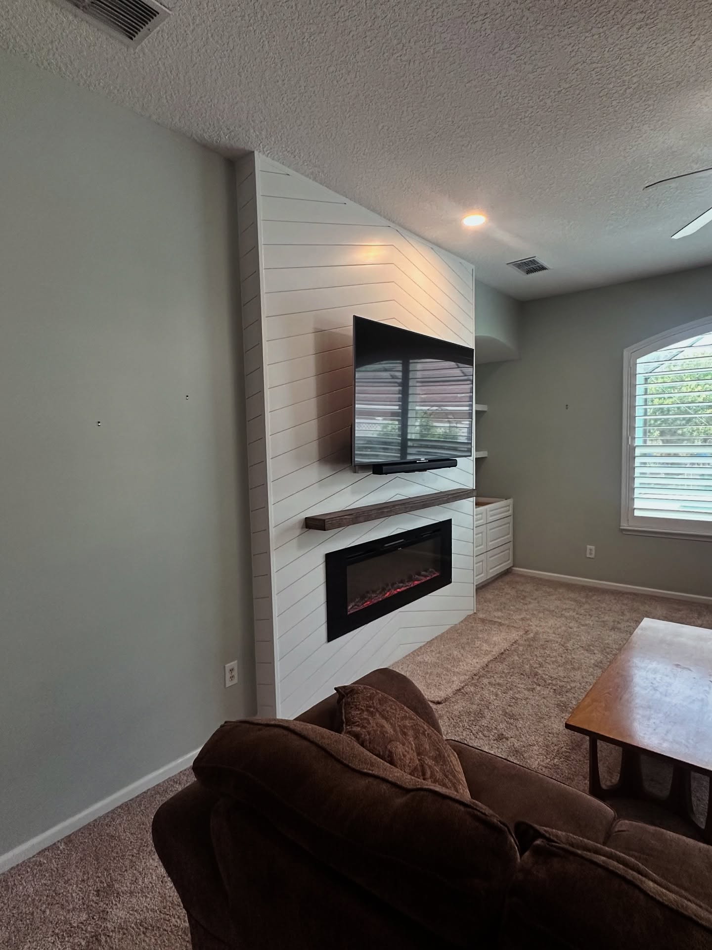 Wall-mounted TV with under-cabinet storage by AVP Construction JAX — Jacksonville & St. John's County, FL
