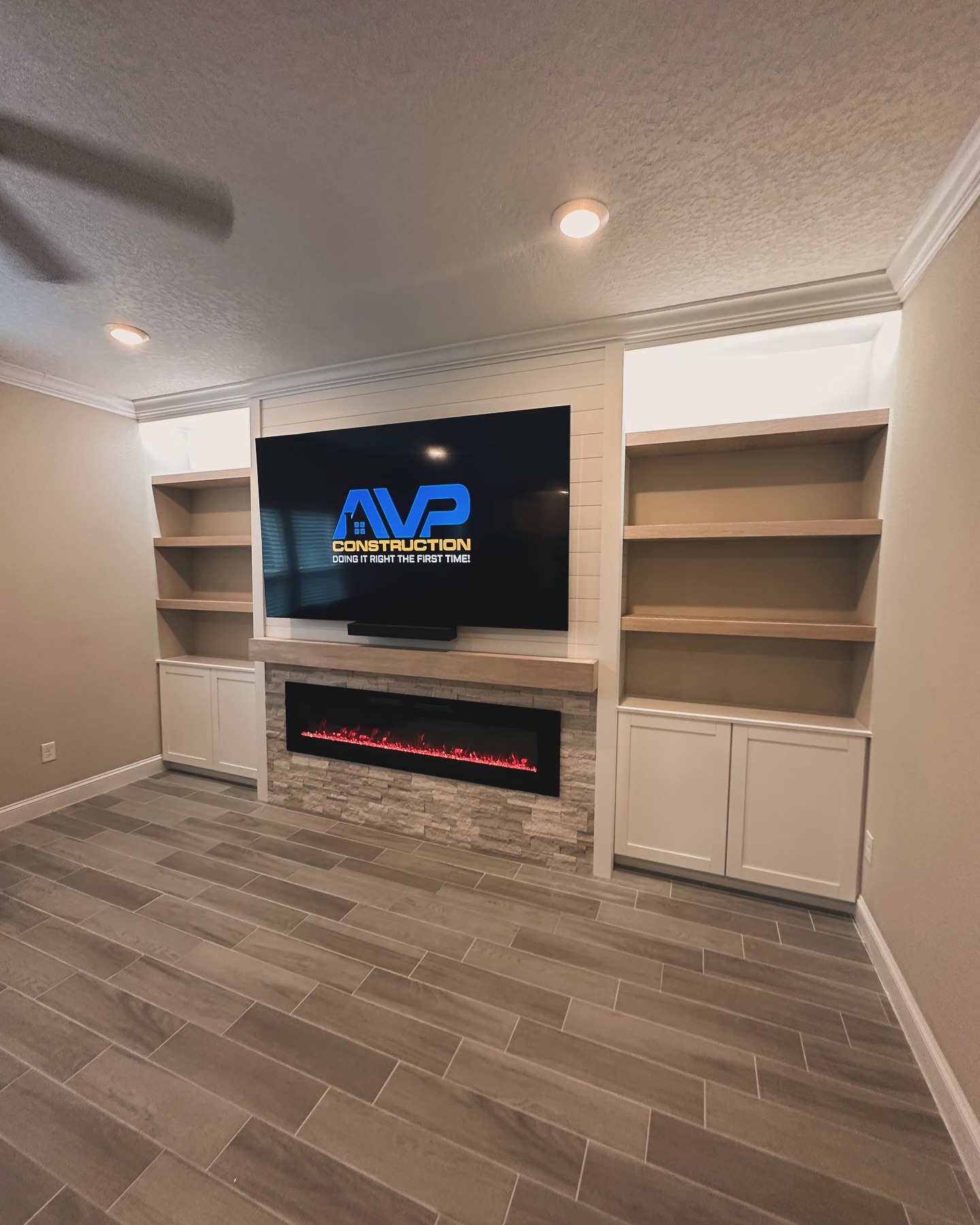 Built-in TV cabinet flanked by display shelving by AVP Construction JAX — Jacksonville & St. John's County, FL