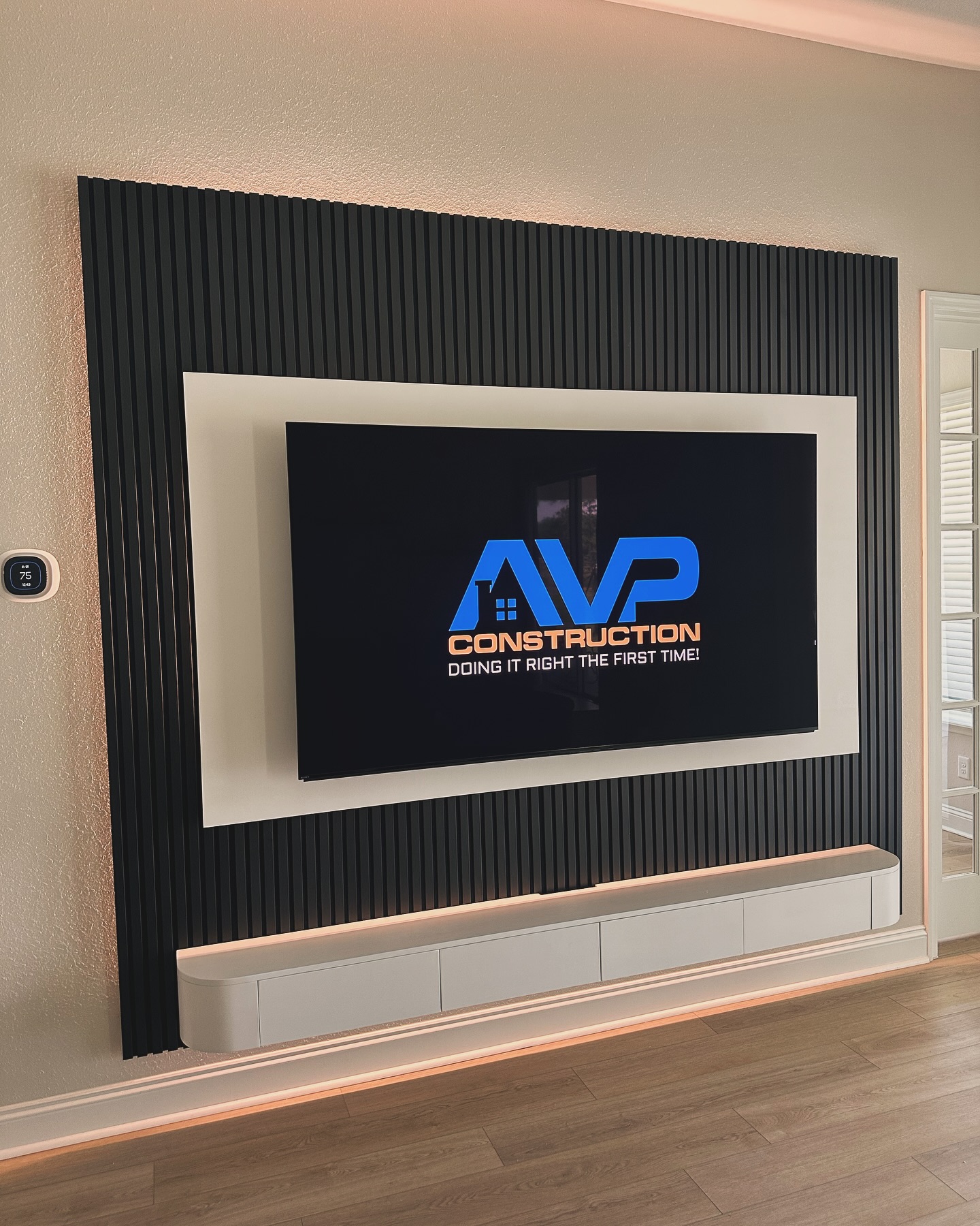 Custom living-room media wall with paneling by AVP Construction JAX — Jacksonville & St. John's County, FL