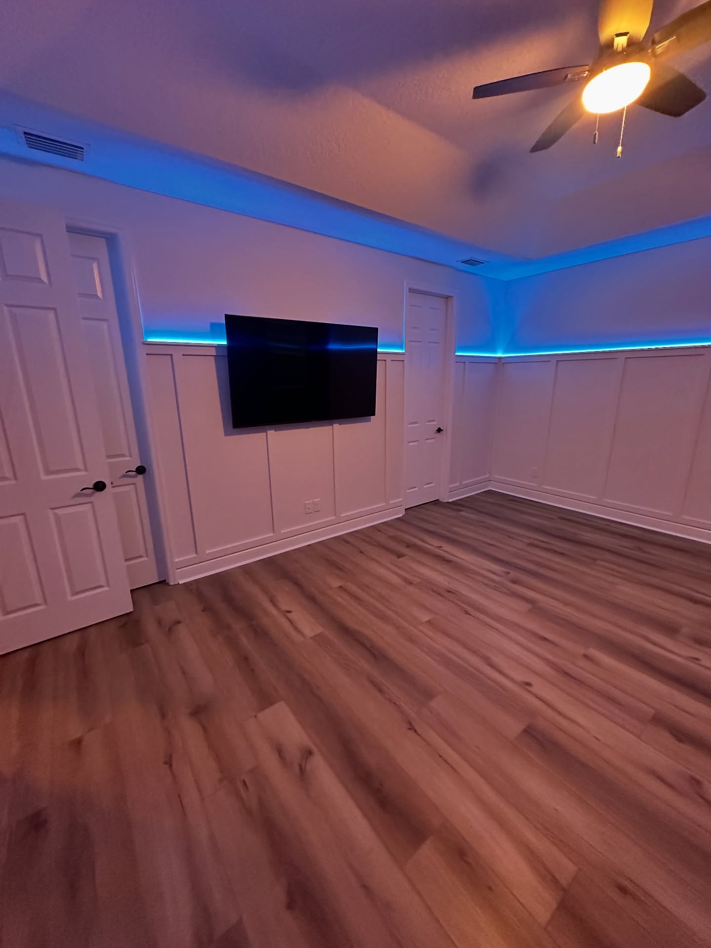 Wall-mounted TV with under-cabinet storage by AVP Construction JAX — Jacksonville & St. John's County, FL