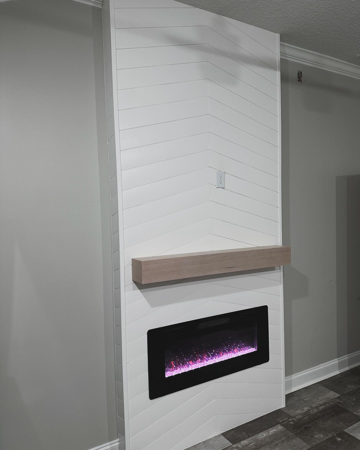 Modern entertainment center with electric fireplace by AVP Construction JAX — Jacksonville & St. John's County, FL