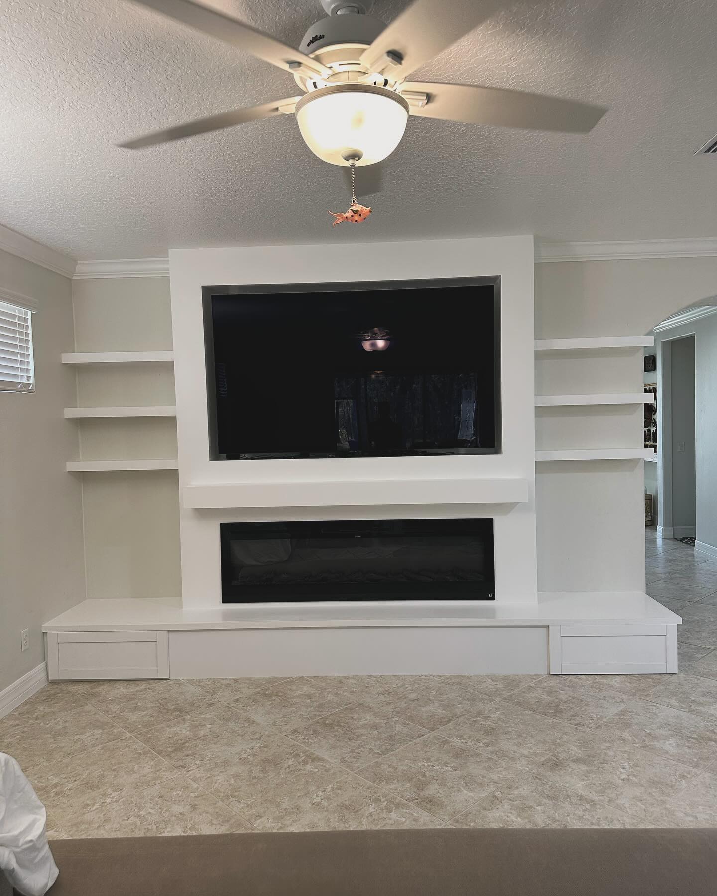Built-in TV cabinet flanked by display shelving by AVP Construction JAX — Jacksonville & St. John's County, FL