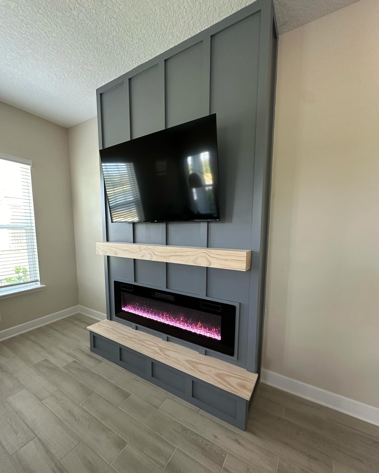 Custom living-room media wall with paneling by AVP Construction JAX — Jacksonville & St. John's County, FL