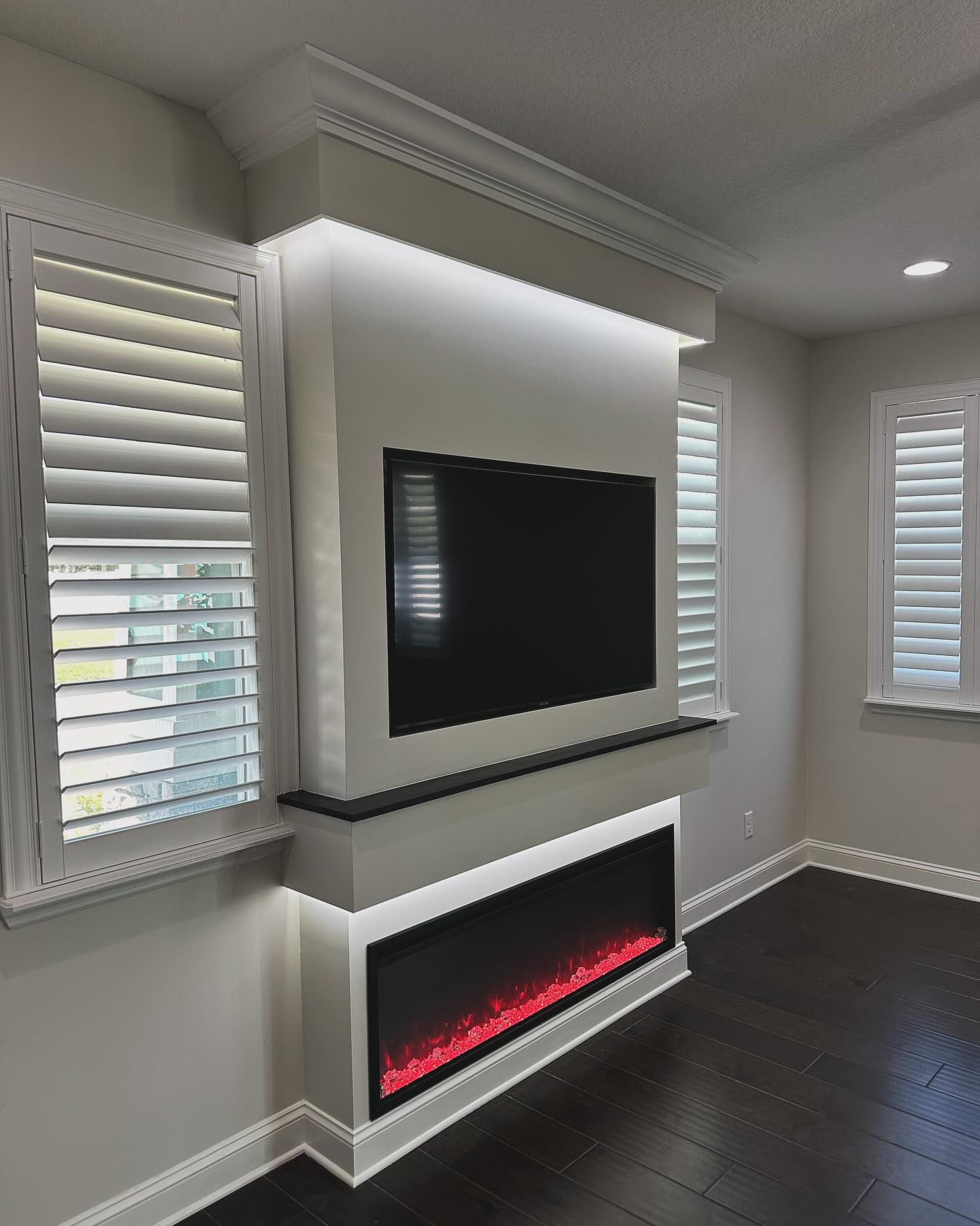 Wall-mounted TV with under-cabinet storage by AVP Construction JAX — Jacksonville & St. John's County, FL