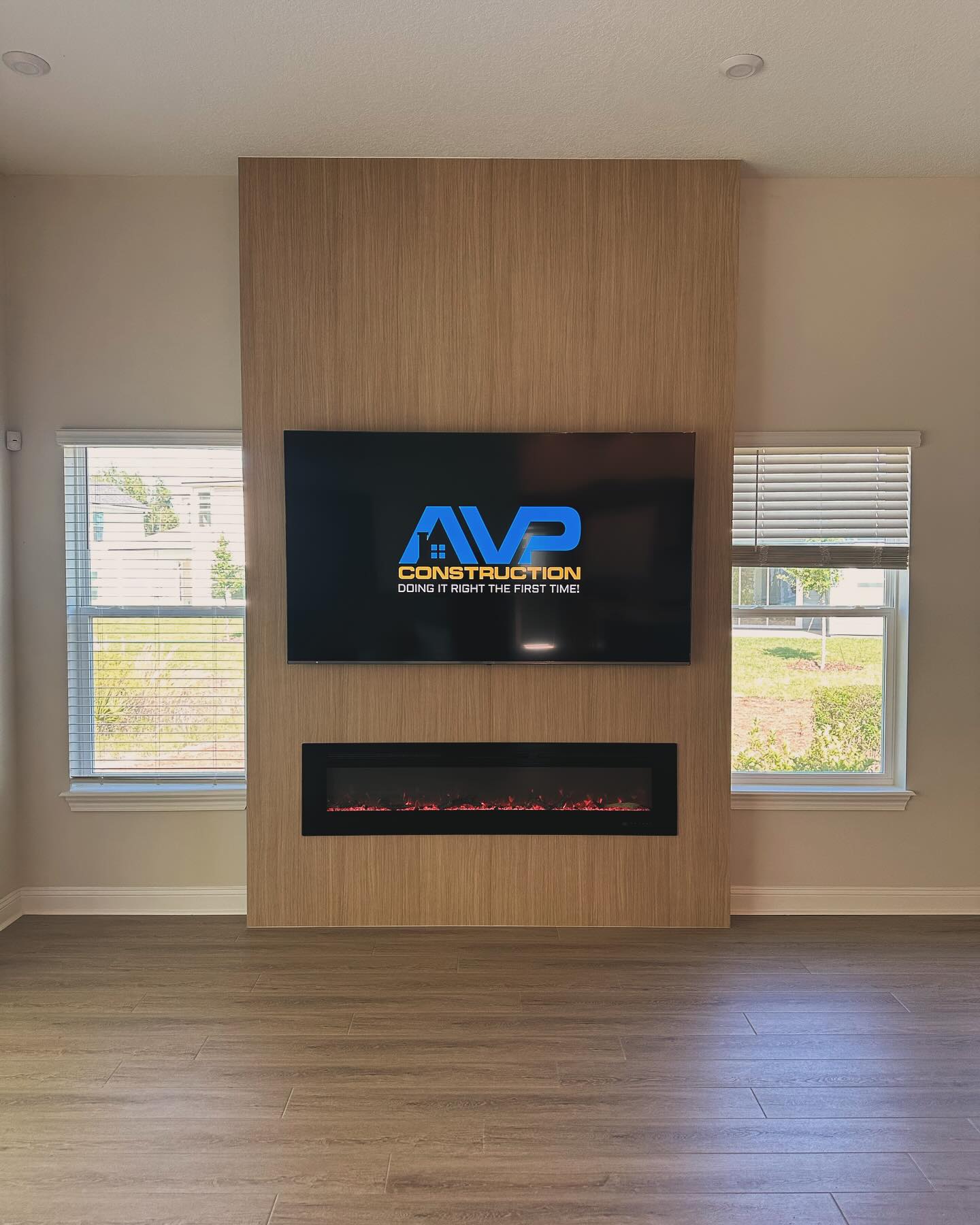 Modern entertainment center with electric fireplace by AVP Construction JAX — Jacksonville & St. John's County, FL
