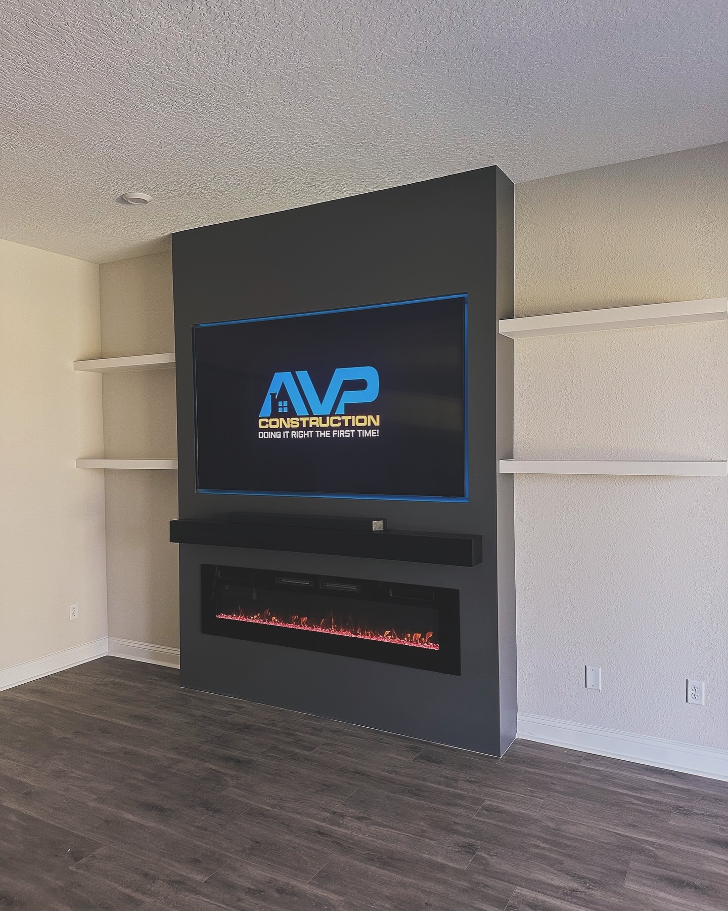 Wall-mounted TV with under-cabinet storage by AVP Construction JAX — Jacksonville & St. John's County, FL