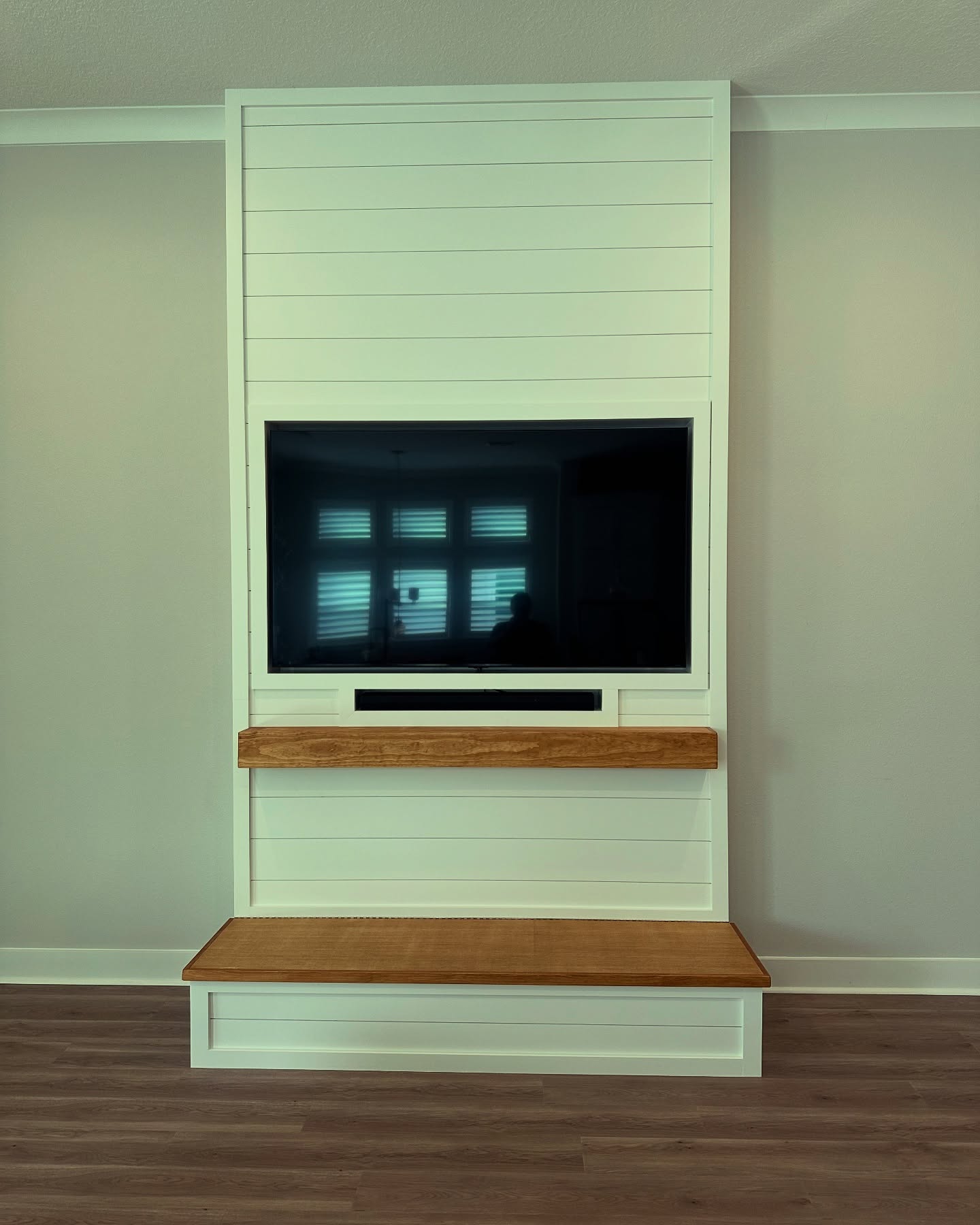 Modern entertainment center with electric fireplace by AVP Construction JAX — Jacksonville & St. John's County, FL