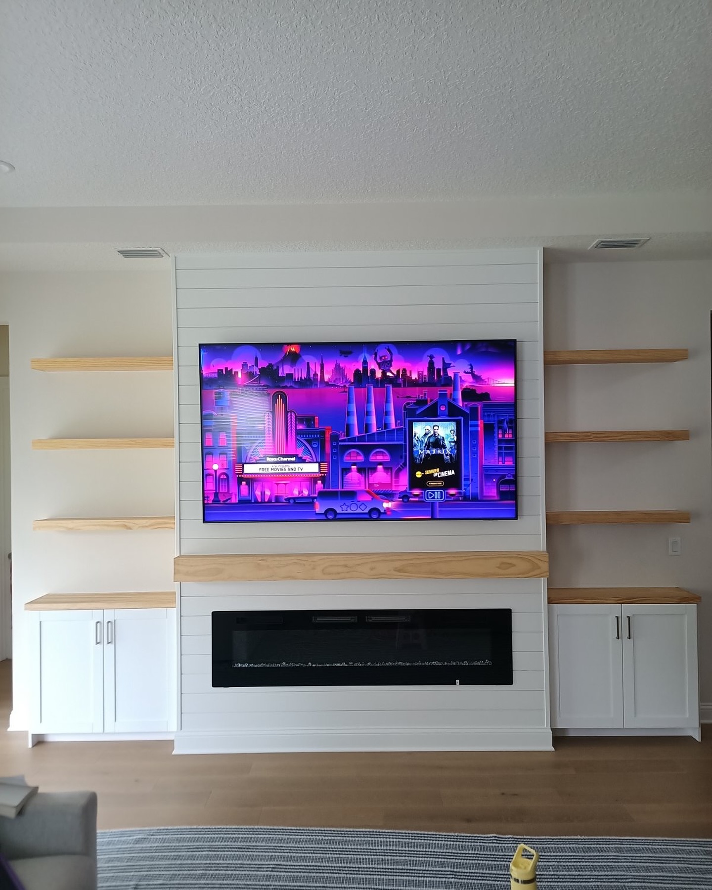 Wall-mounted TV with under-cabinet storage by AVP Construction JAX — Jacksonville & St. John's County, FL