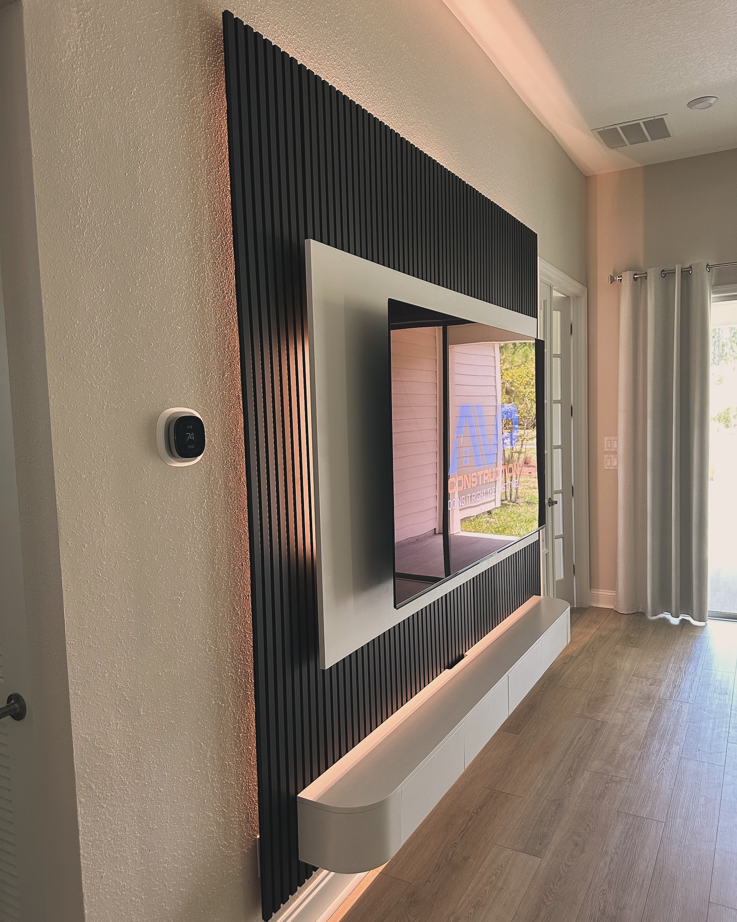 Modern entertainment center with electric fireplace by AVP Construction JAX — Jacksonville & St. John's County, FL