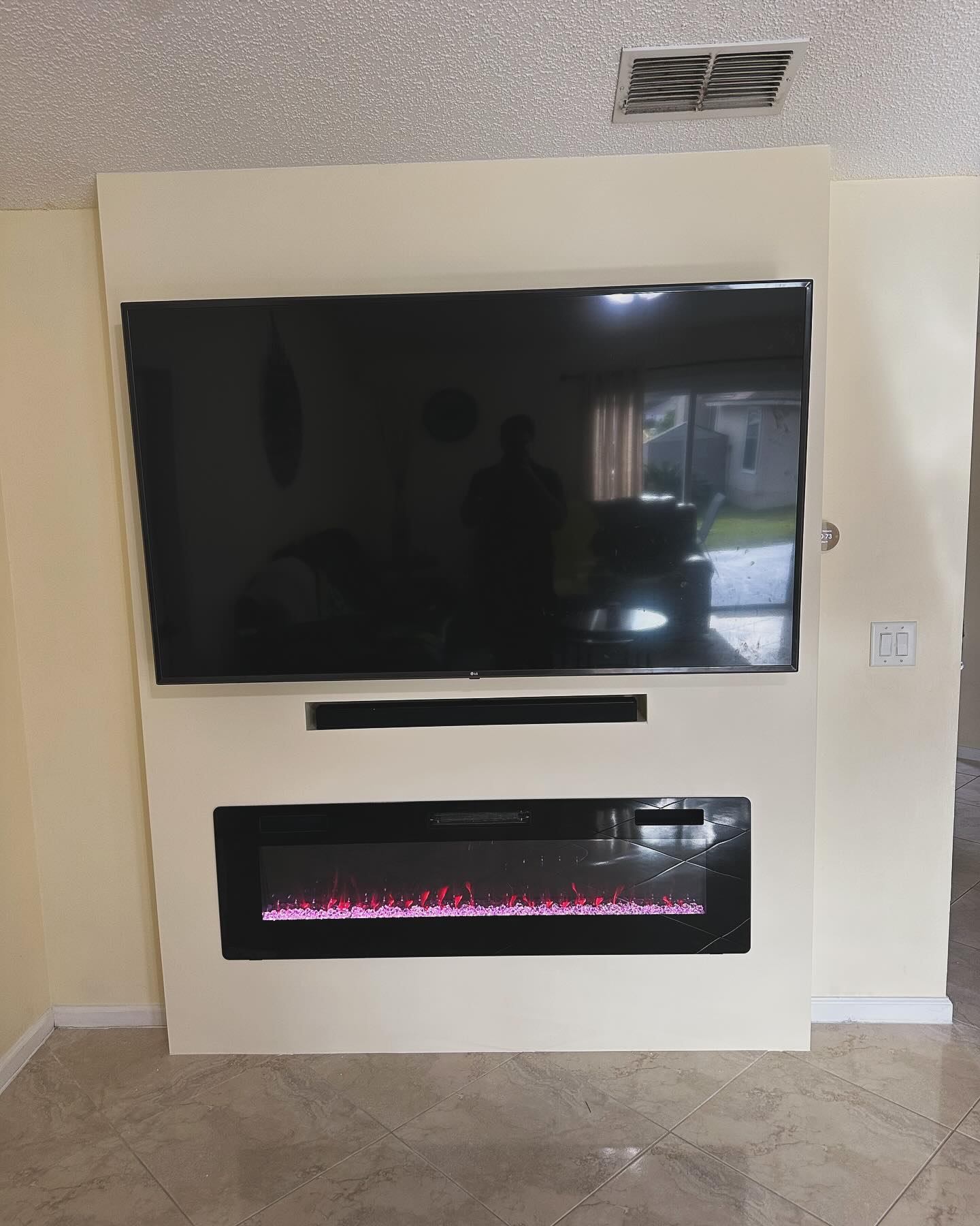 Custom living-room media wall with paneling by AVP Construction JAX — Jacksonville & St. John's County, FL