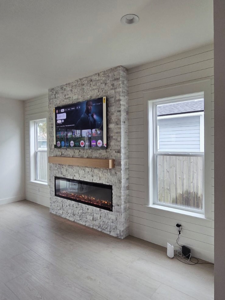 Slat-wall TV feature with hidden wiring by AVP Construction JAX — Jacksonville & St. John's County, FL