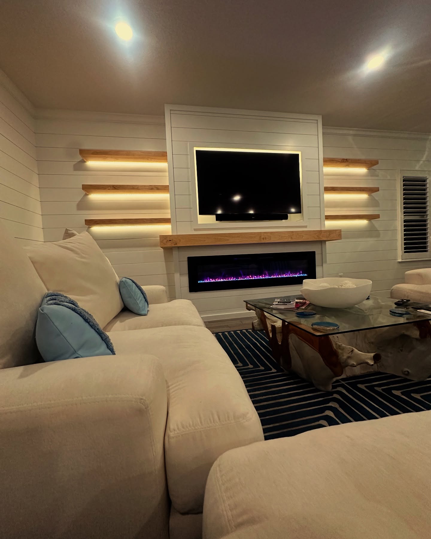 Modern entertainment center with electric fireplace by AVP Construction JAX — Jacksonville & St. John's County, FL