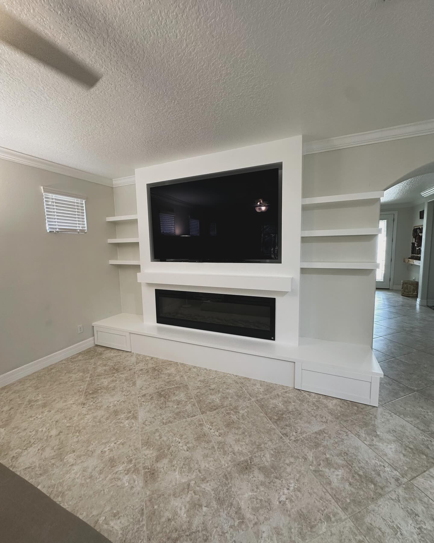 Floor-to-ceiling media wall with custom millwork by AVP Construction JAX — Jacksonville & St. John's County, FL