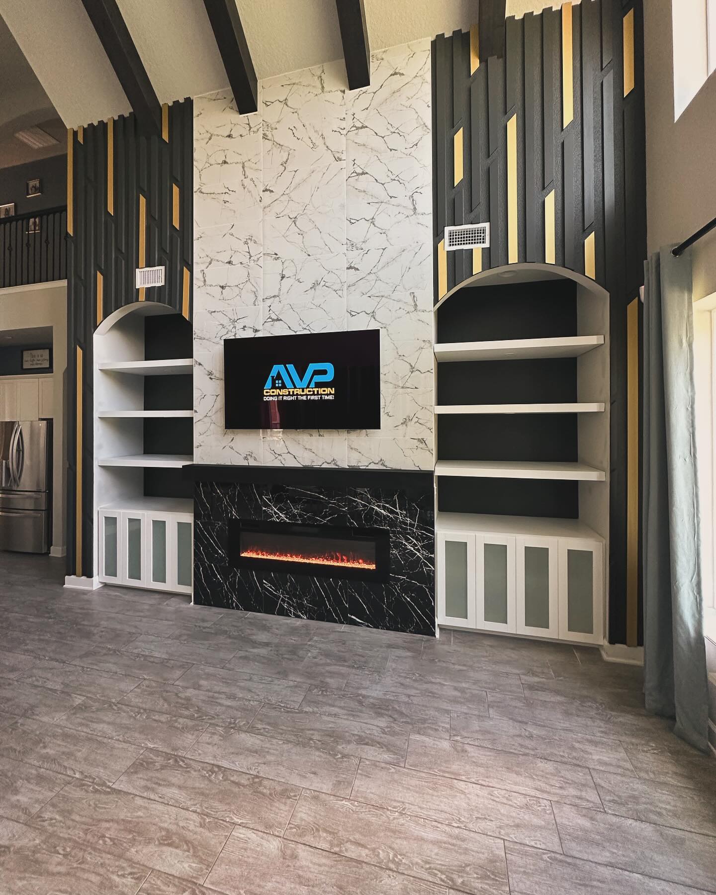 Wall-mounted TV with under-cabinet storage by AVP Construction JAX — Jacksonville & St. John's County, FL