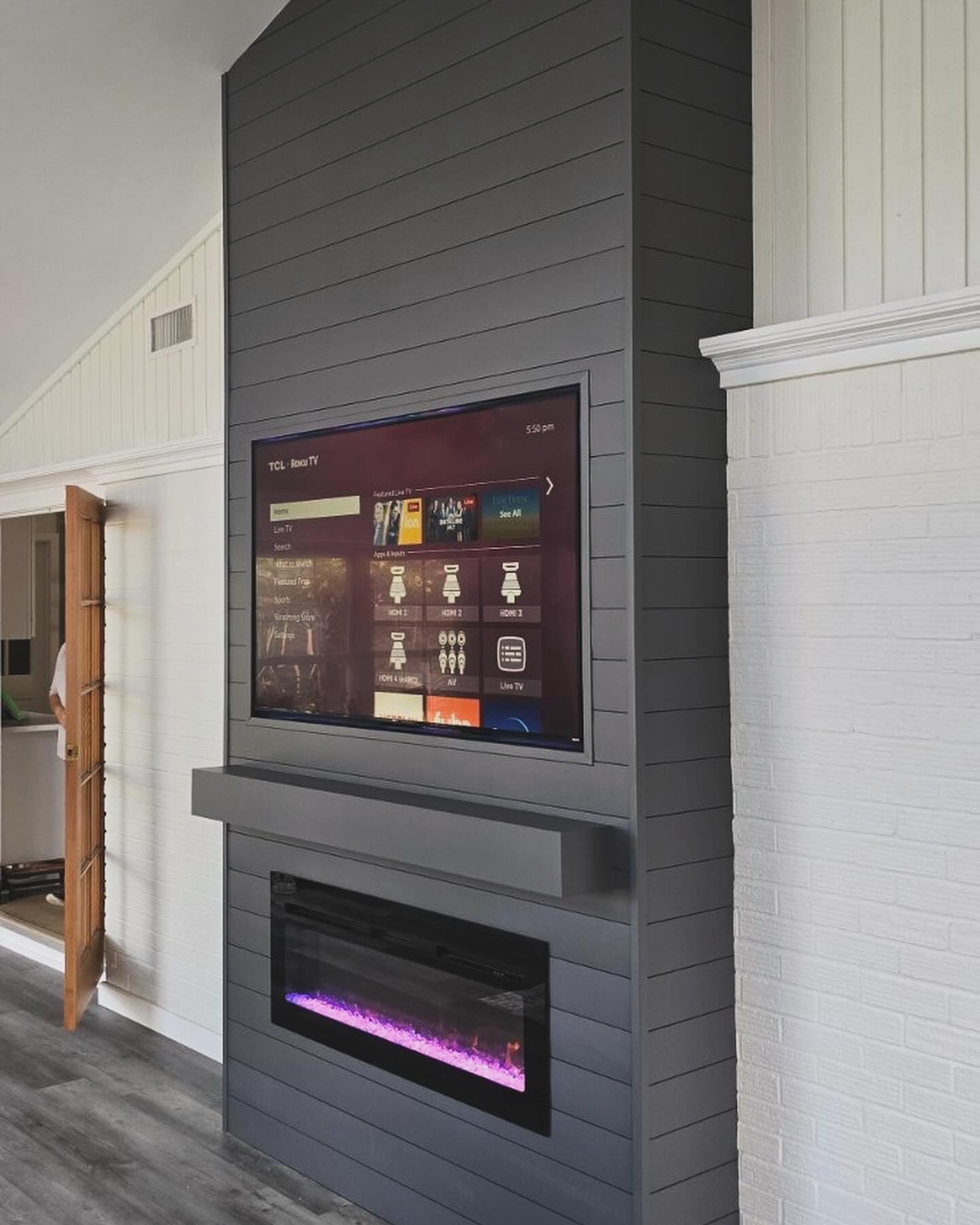 Built-in TV cabinet flanked by display shelving by AVP Construction JAX — Jacksonville & St. John's County, FL