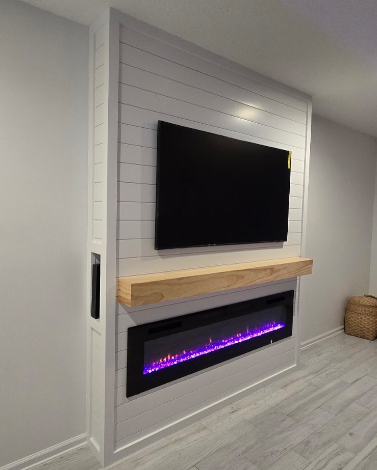 Floor-to-ceiling media wall with custom millwork by AVP Construction JAX — Jacksonville & St. John's County, FL