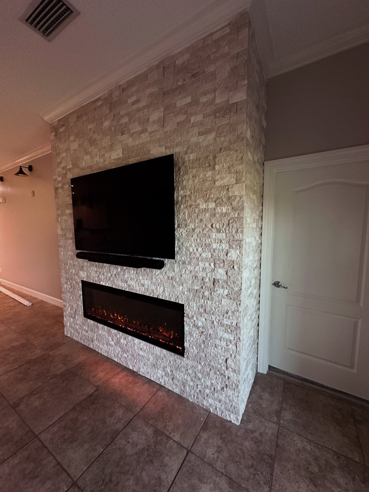 Wall-mounted TV with under-cabinet storage by AVP Construction JAX — Jacksonville & St. John's County, FL