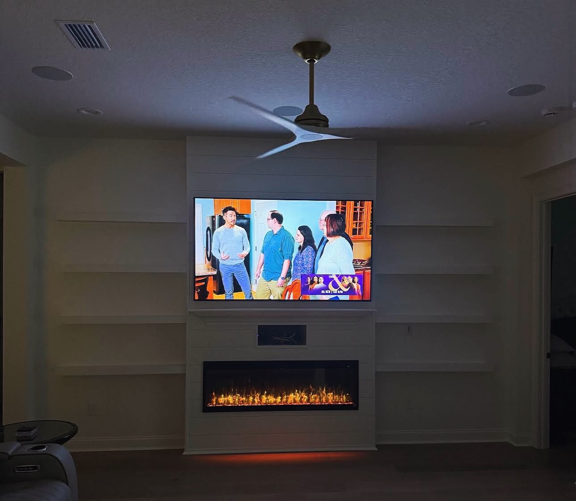Modern entertainment center with electric fireplace by AVP Construction JAX — Jacksonville & St. John's County, FL