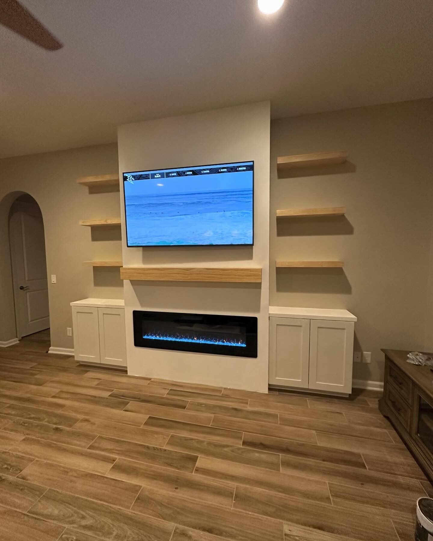Floor-to-ceiling media wall with custom millwork by AVP Construction JAX — Jacksonville & St. John's County, FL