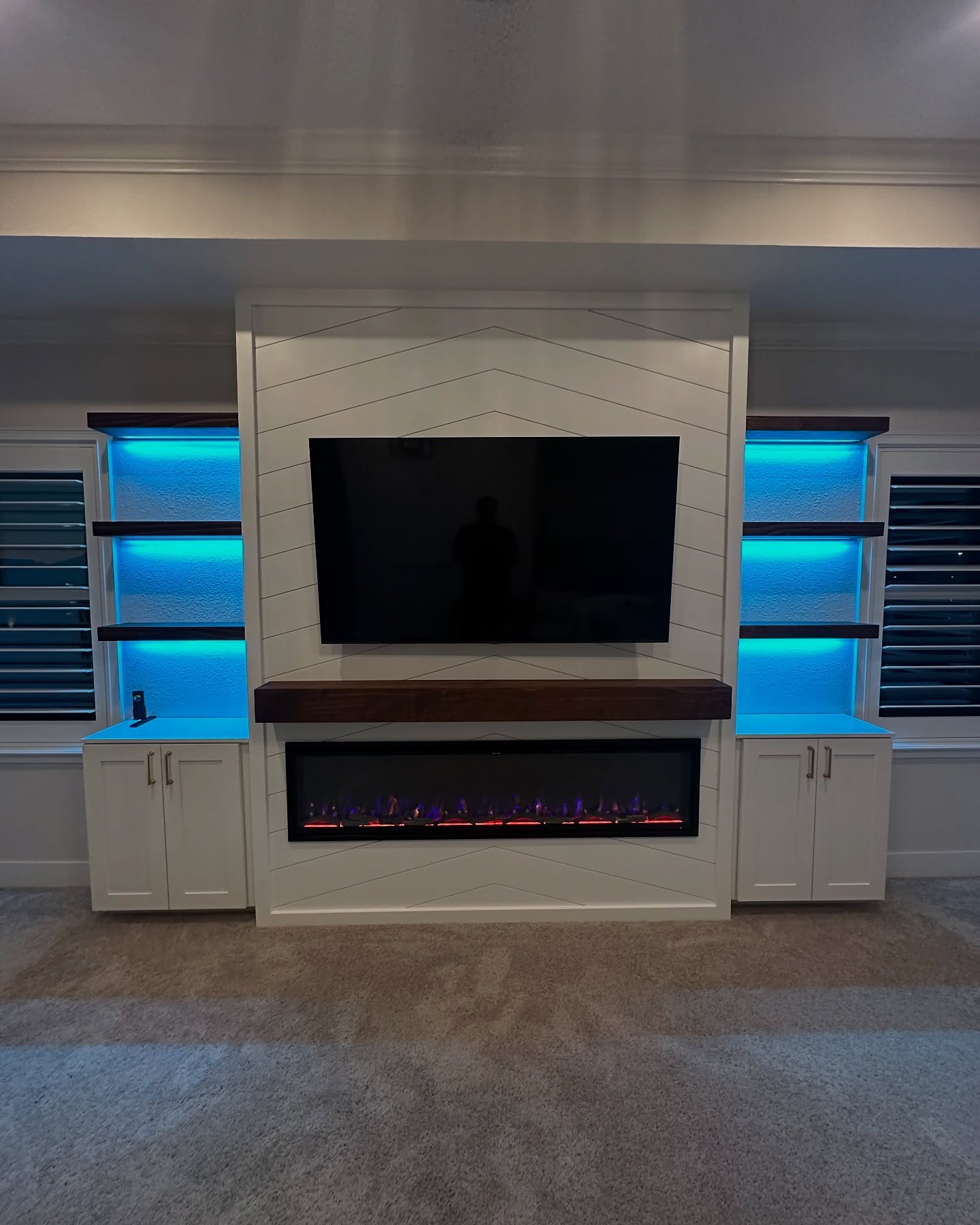 Wall-mounted TV with under-cabinet storage by AVP Construction JAX — Jacksonville & St. John's County, FL