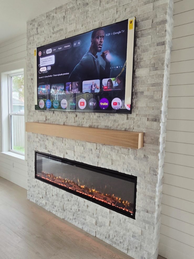 Modern entertainment center with electric fireplace by AVP Construction JAX — Jacksonville & St. John's County, FL