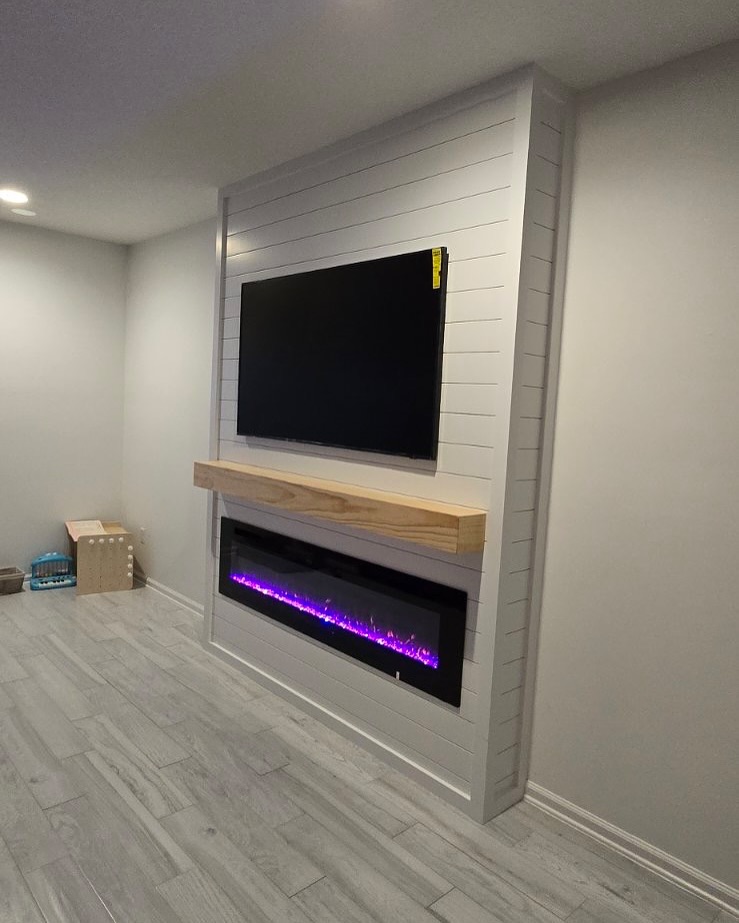 Built-in TV cabinet flanked by display shelving by AVP Construction JAX — Jacksonville & St. John's County, FL