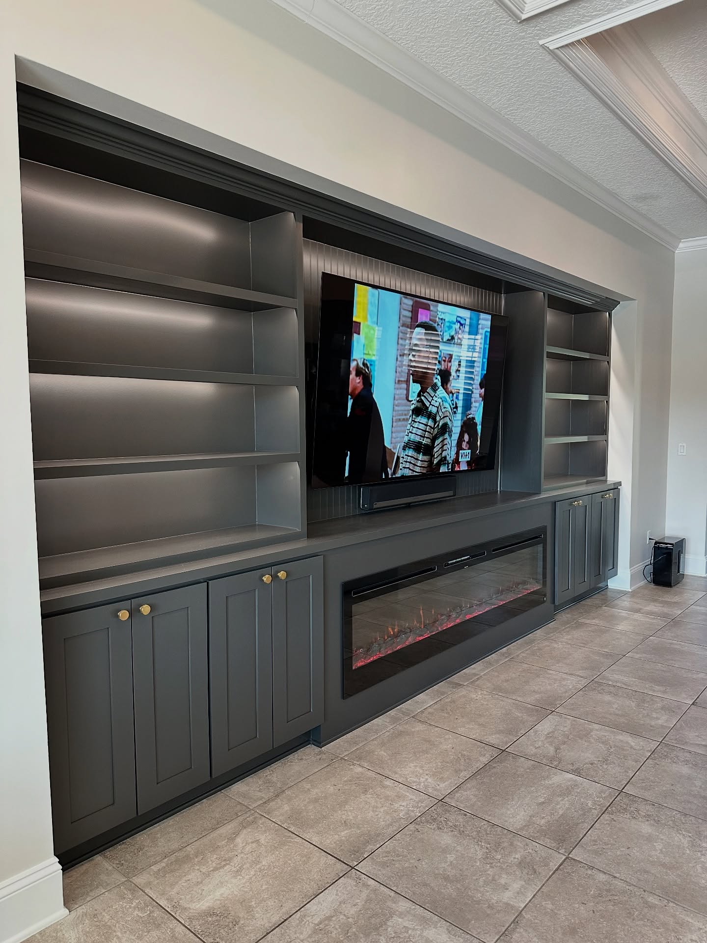 Floor-to-ceiling media wall with custom millwork by AVP Construction JAX — Jacksonville & St. John's County, FL