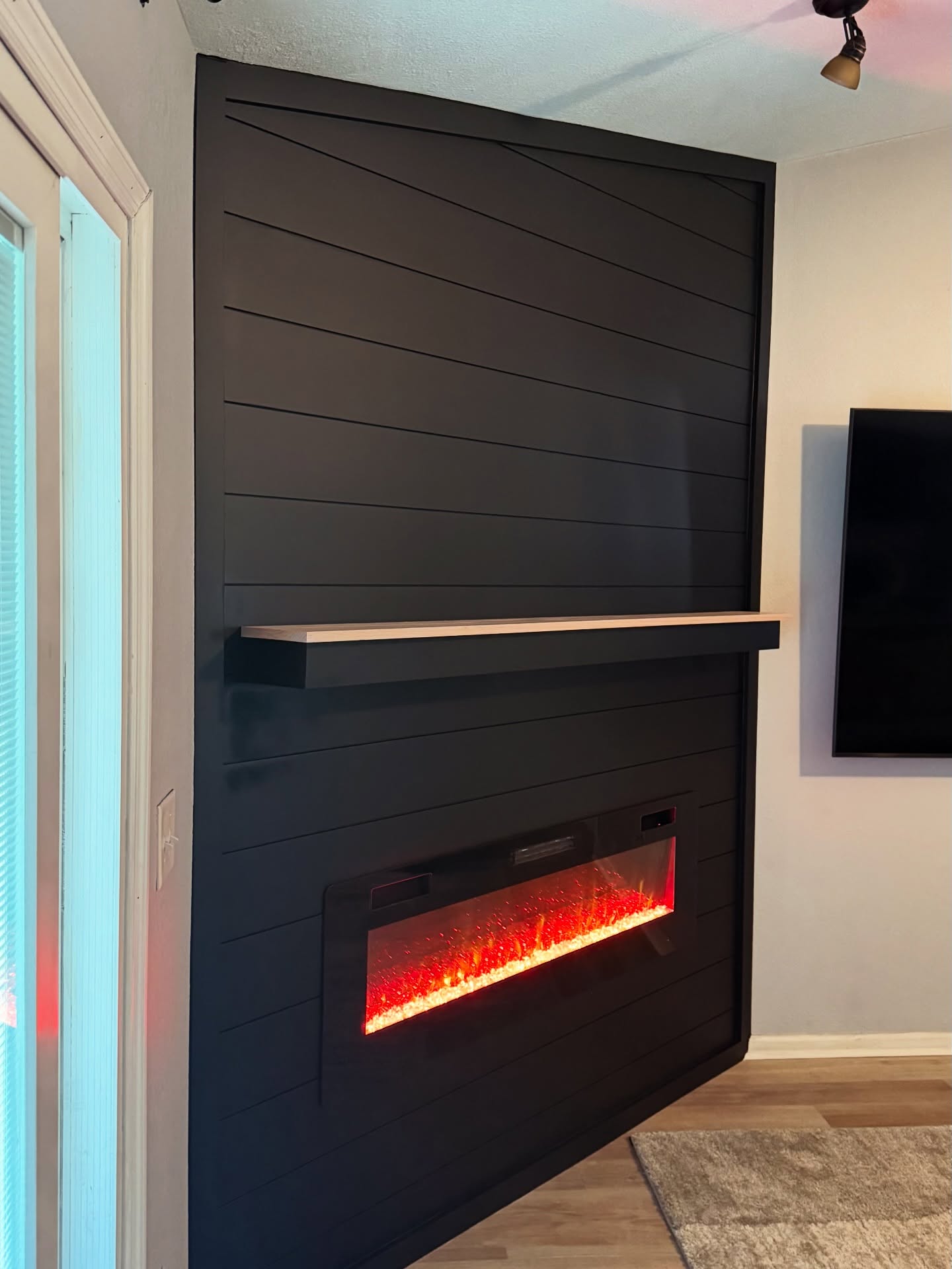 Built-in TV cabinet flanked by display shelving by AVP Construction JAX — Jacksonville & St. John's County, FL