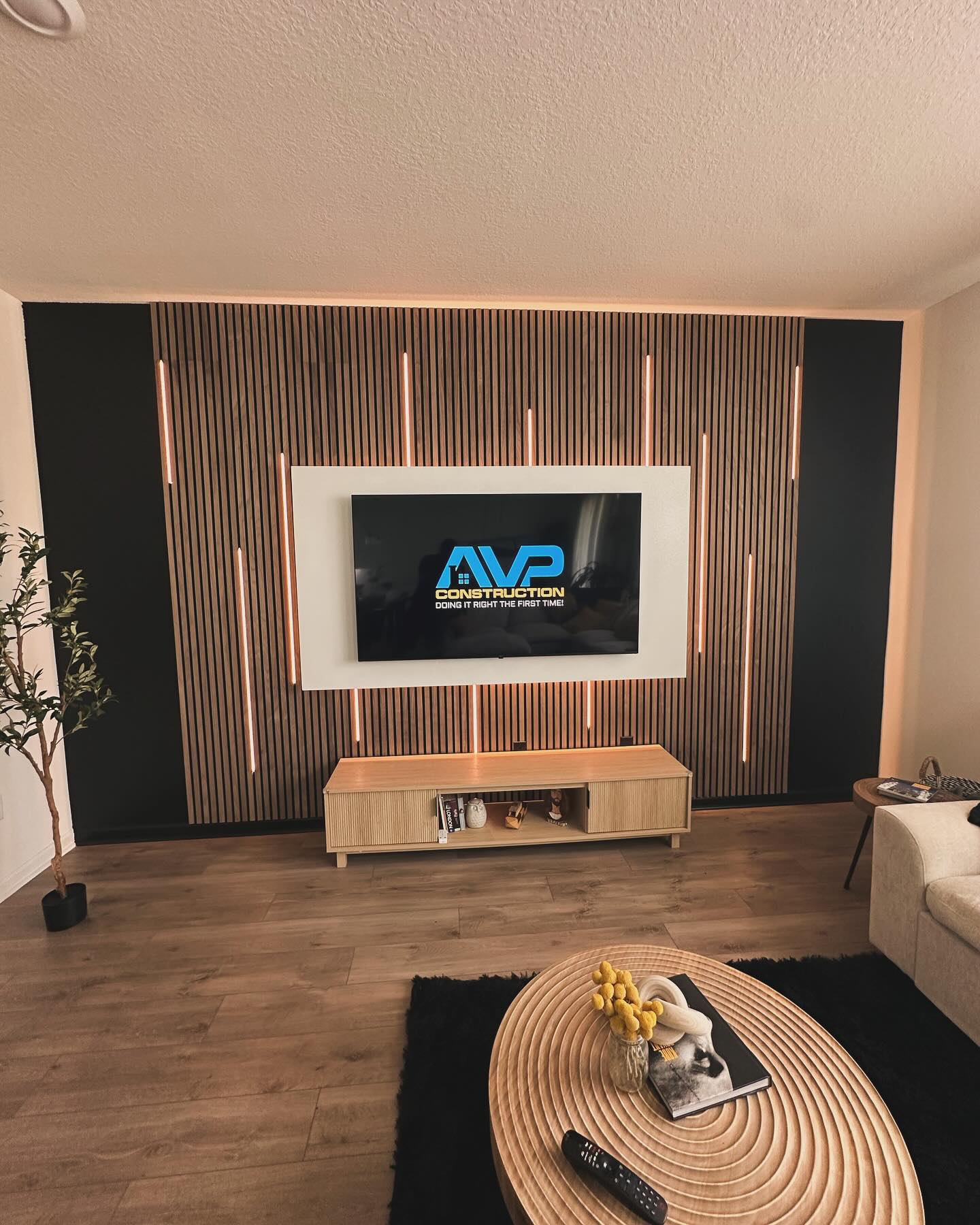 Custom living-room media wall with paneling by AVP Construction JAX — Jacksonville & St. John's County, FL