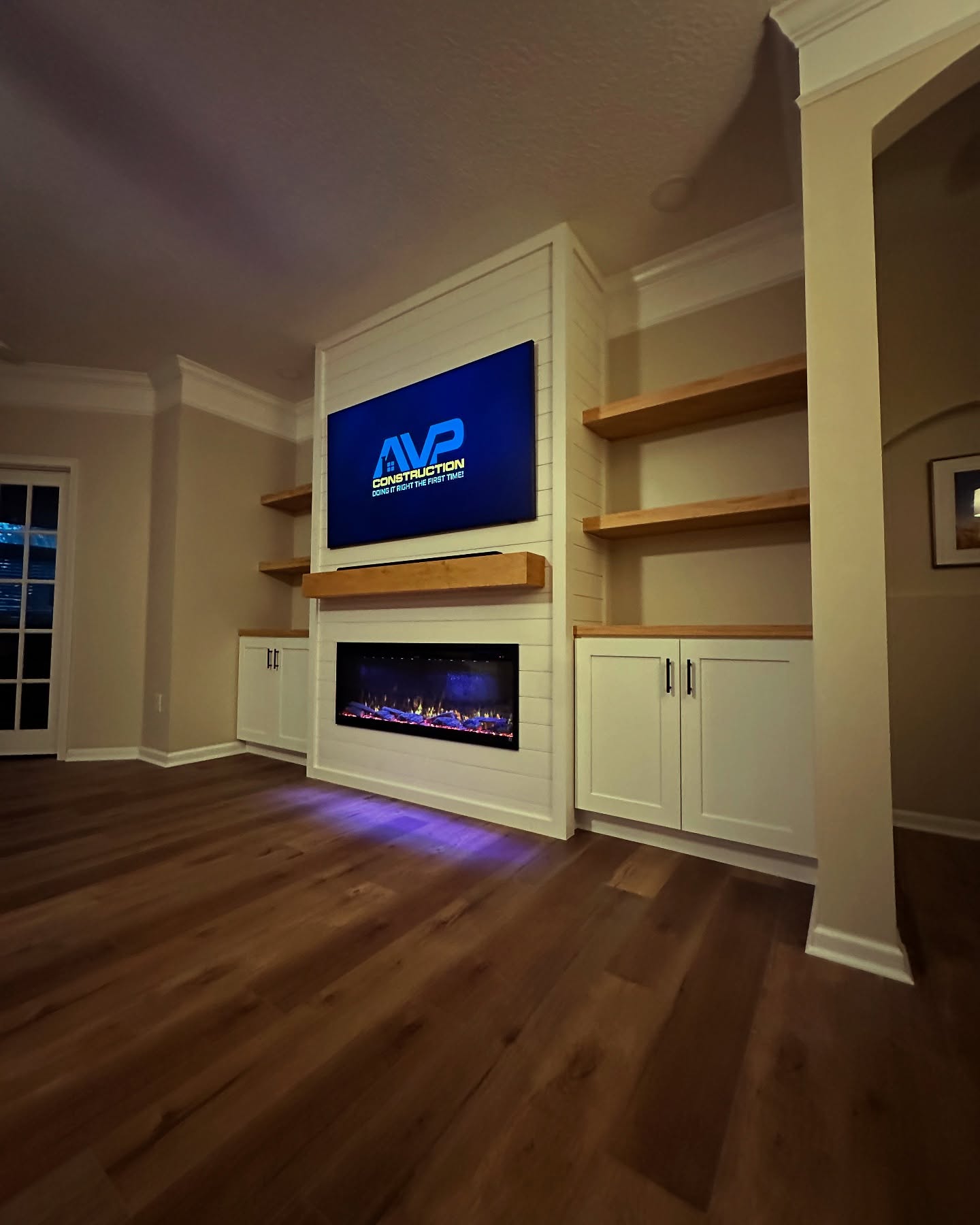 Floating-shelf TV built-in with shaker cabinets by AVP Construction JAX — Jacksonville & St. John's County, FL