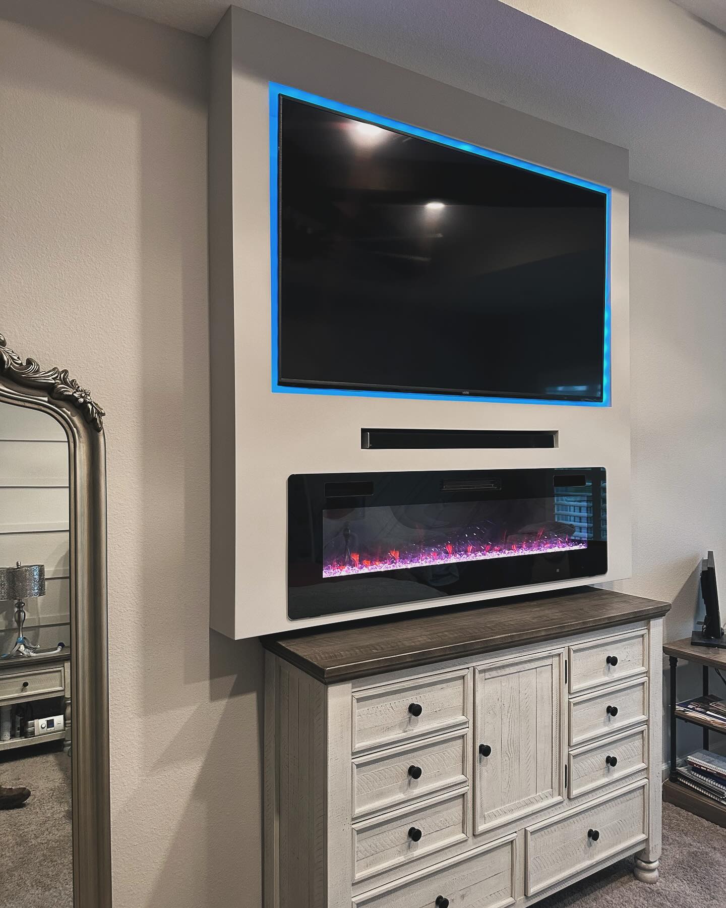 Modern entertainment center with electric fireplace by AVP Construction JAX — Jacksonville & St. John's County, FL